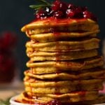 Closeup of a large stack of Apple Cider Pumpkin Pancakes with Cranberries