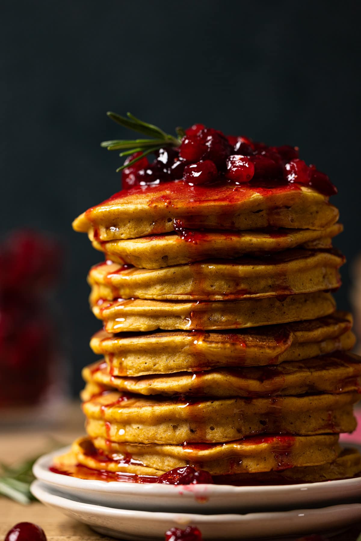 Closeup of a large stack of Apple Cider Pumpkin Pancakes with Cranberries