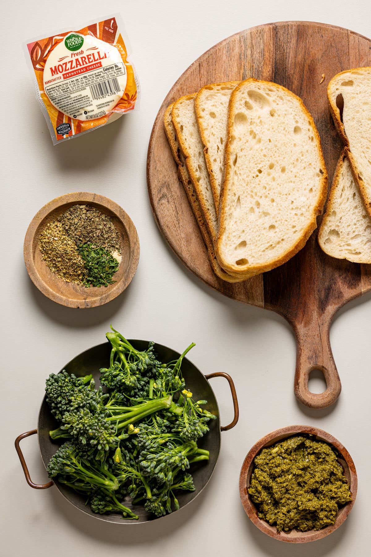 Ingredients for Broccoli Pesto Grilled Cheese including bread, mozzarella, and seasonings