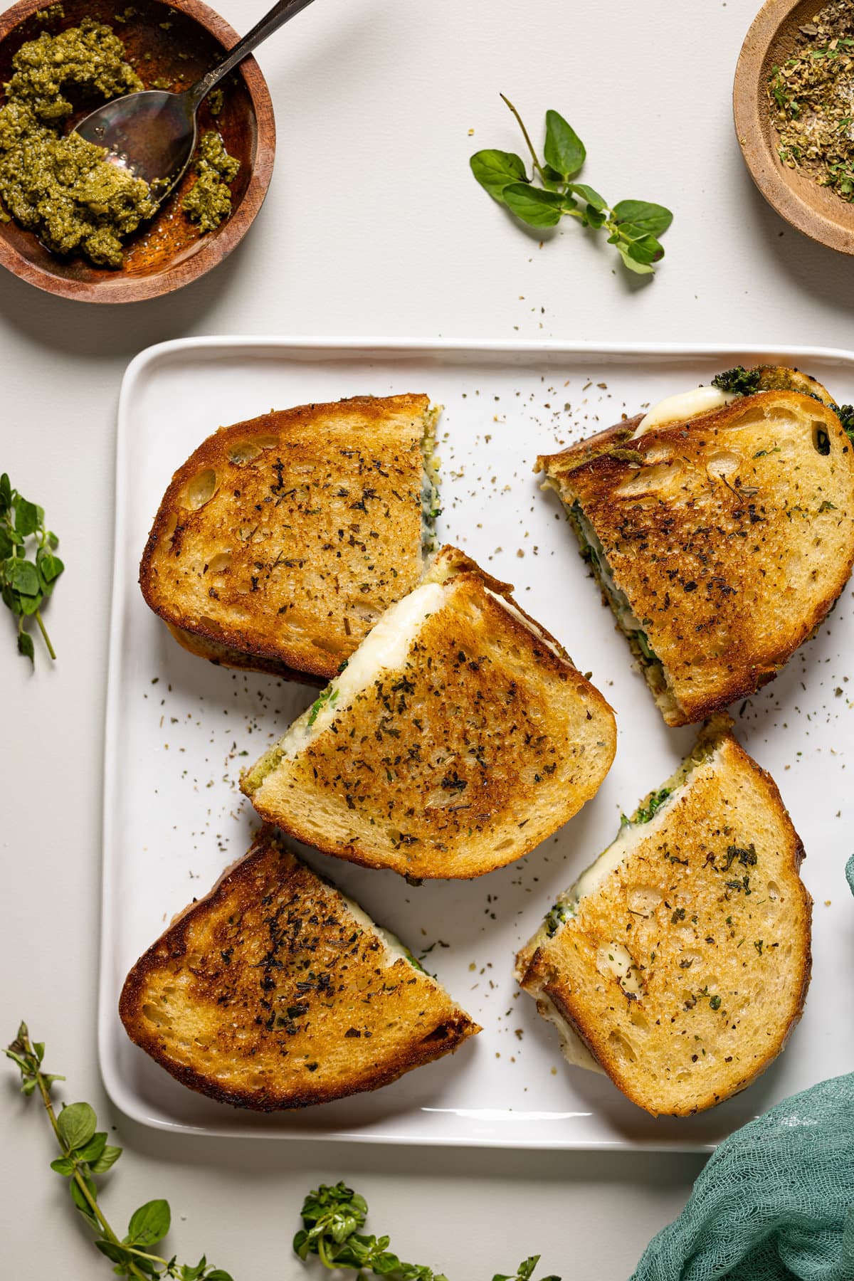 Plate of Broccoli Pesto Grilled Cheese sandwiches cut in half