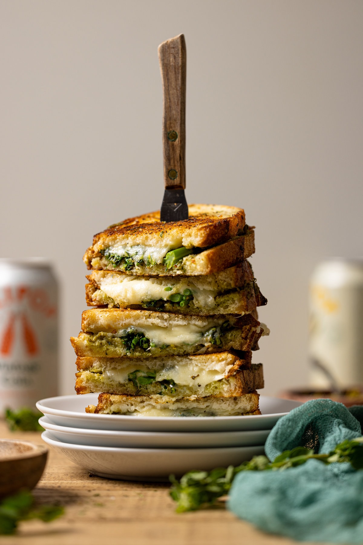 Stack of Broccoli Pesto Grilled Cheese sandwiches on three plates