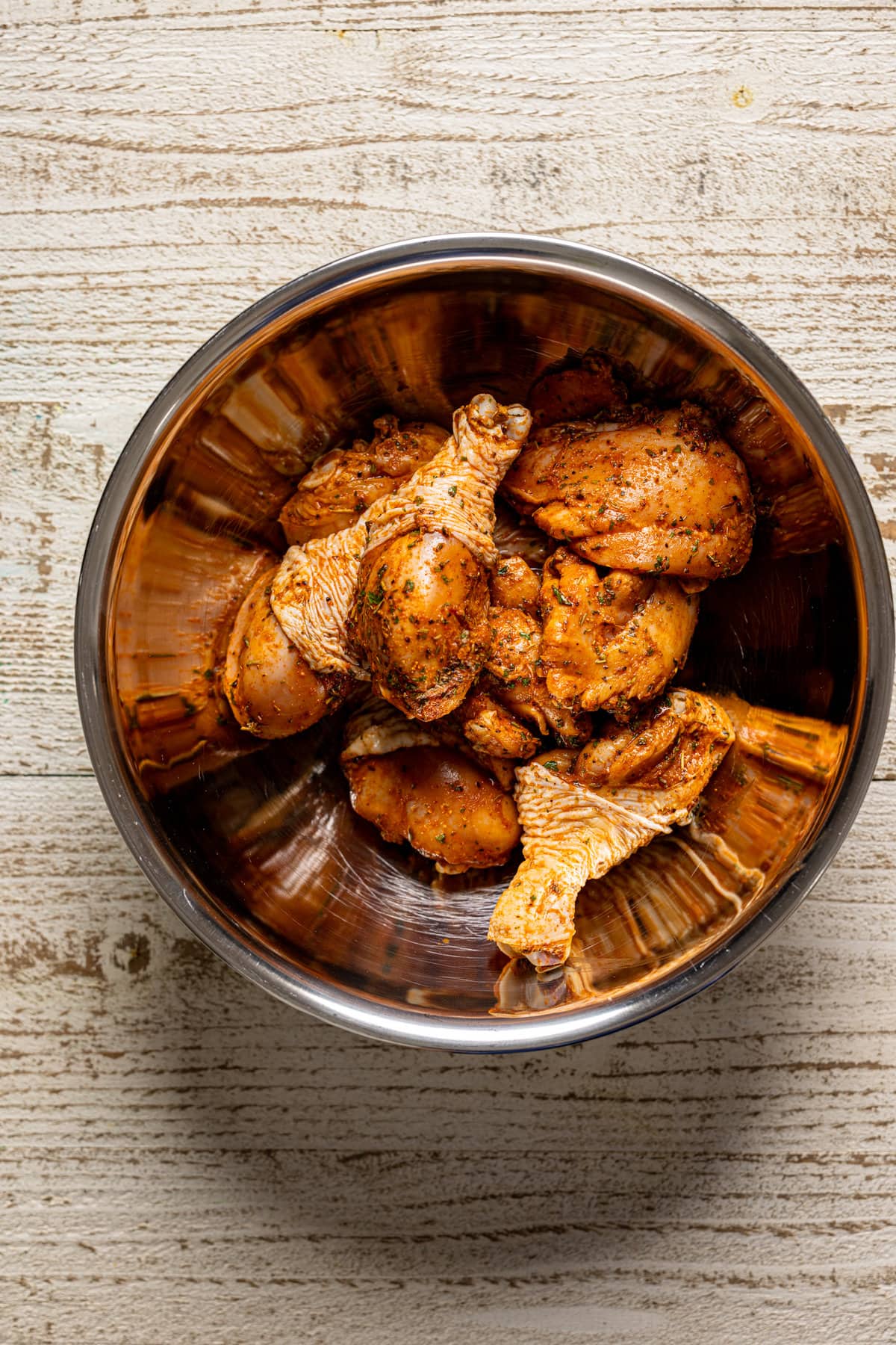 Seasoned chicken in a metal bowl