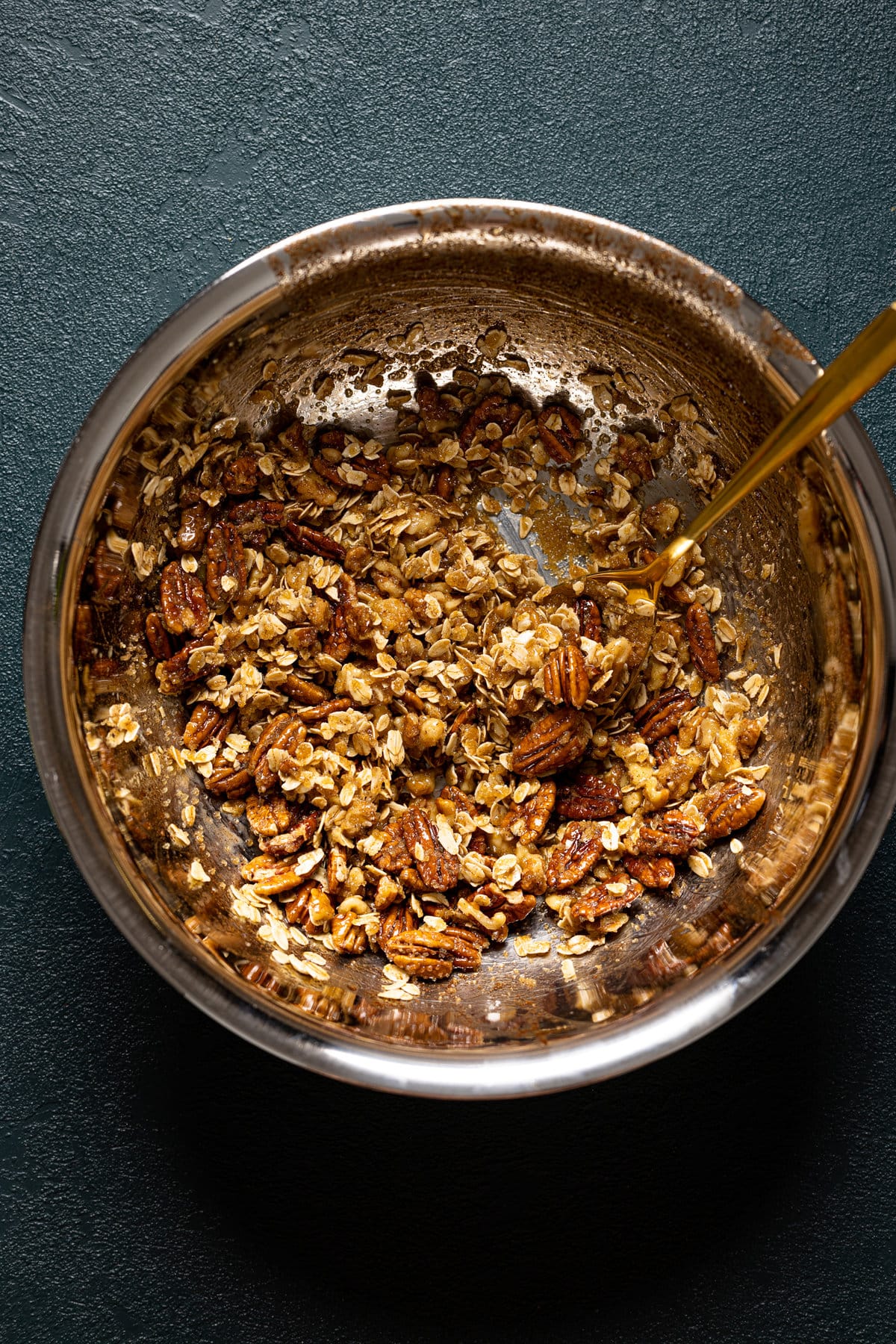 Spoon in a bowl of pecan topping