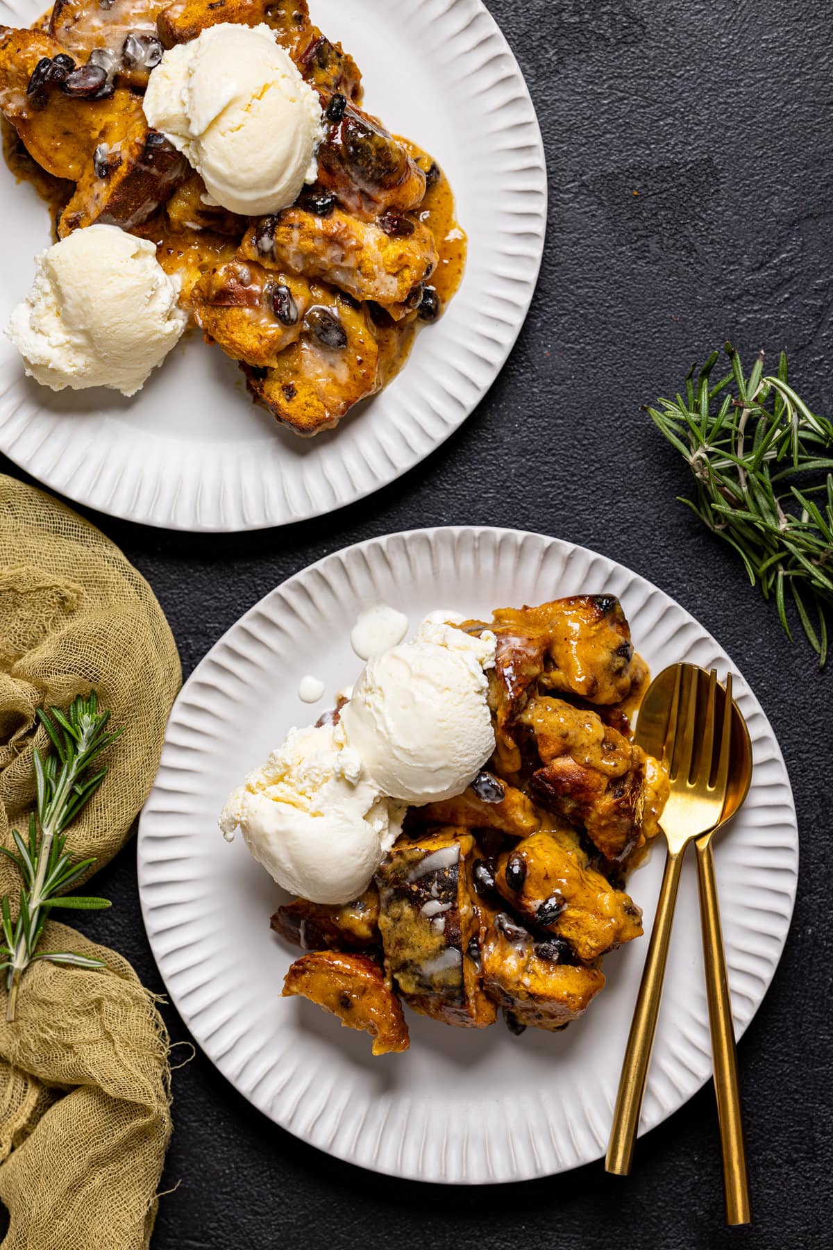 Two plates of Deconstructed Vegan Sweet Potato Bread Pudding with scoops of dairy-free ice cream