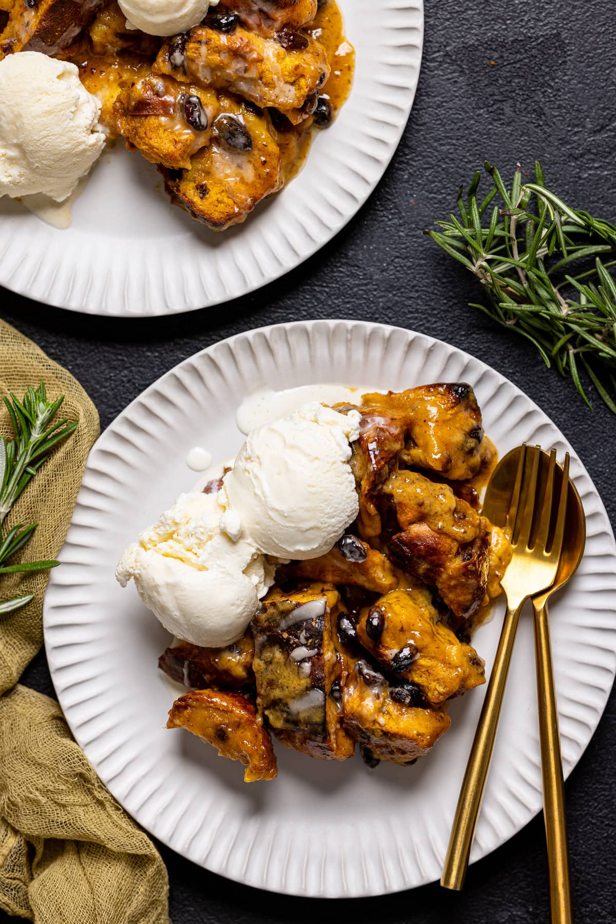 Two plates of Deconstructed Vegan Sweet Potato Bread Pudding with scoops of dairy-free ice cream