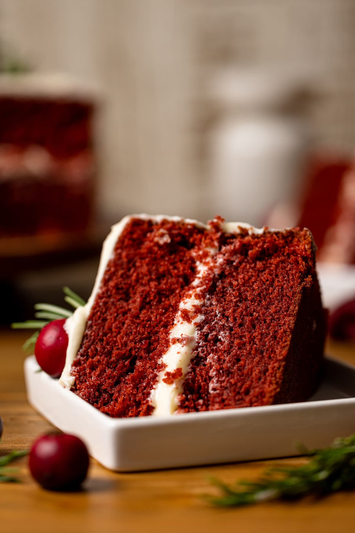 Slice of Red Velvet Cake with Cream Cheese Frosting on its side