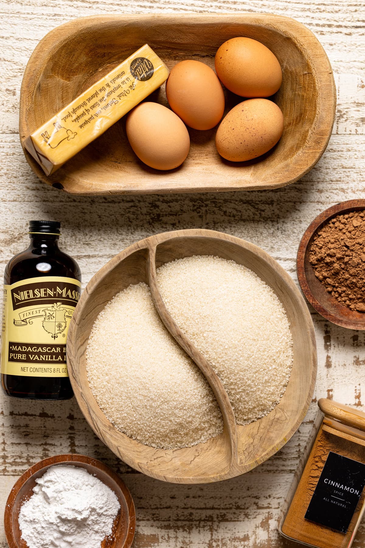 Ingredients for Red Velvet Cake with Cream Cheese Frosting including eggs, vanilla extract, and cinnamon