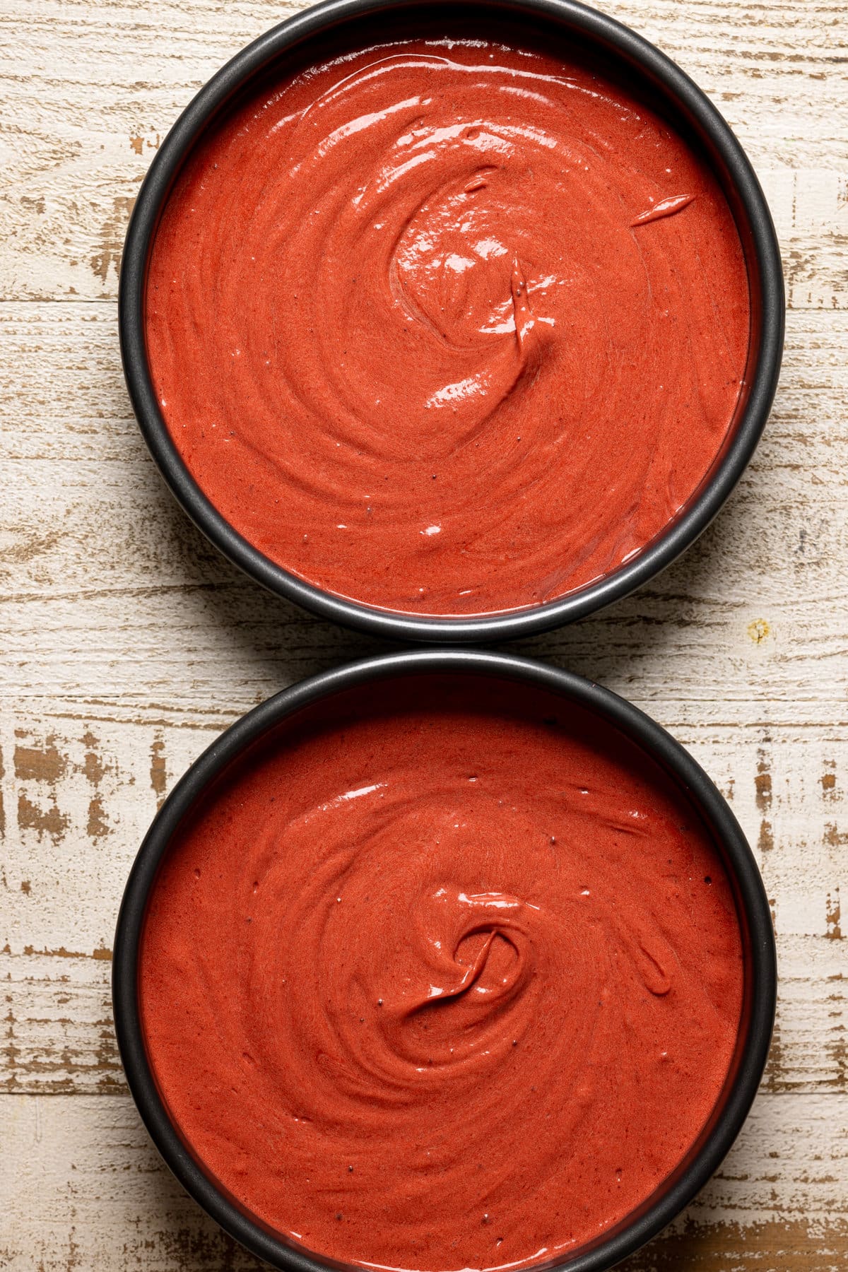 Two round pans filled with Red Velvet Cake batter