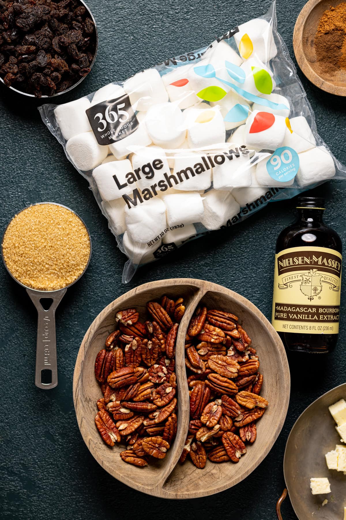 Ingredients for Maple Sweet Potato Casserole including large marshmallows, vanilla extract, and pecans