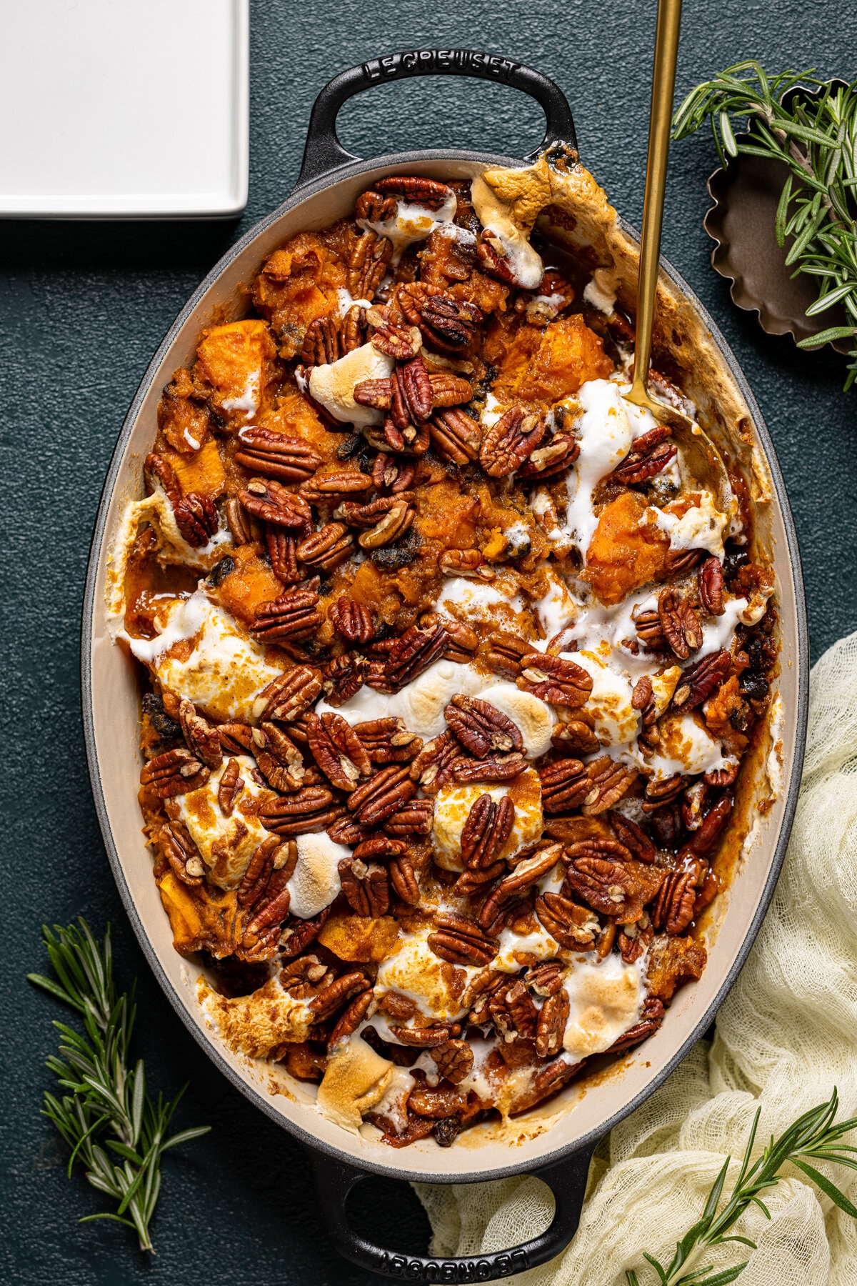 Baking pan of Maple Sweet Potato Casserole with a serving spoon