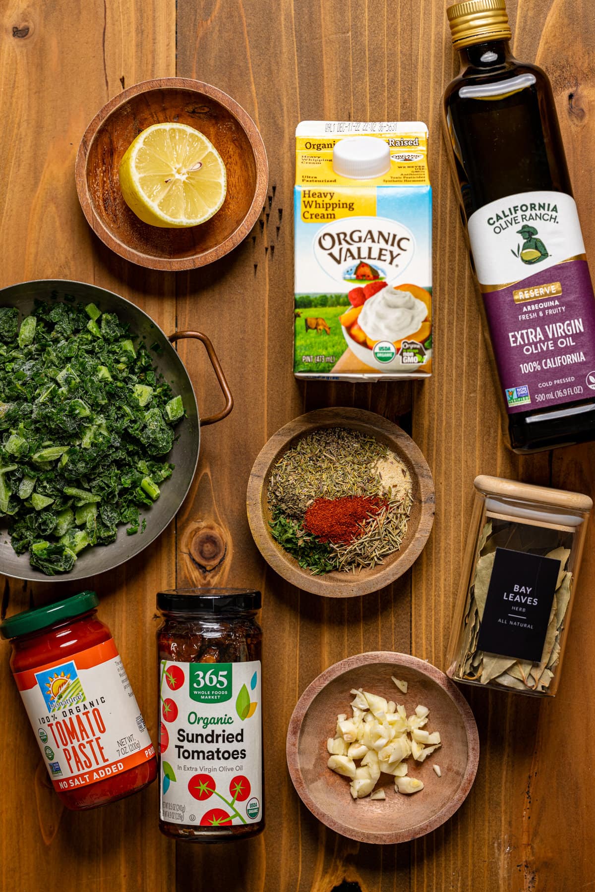 Ingredients for Creamy Tuscan Tortellini Soup including sundried tomatoes, tomato paste, and bay leaves