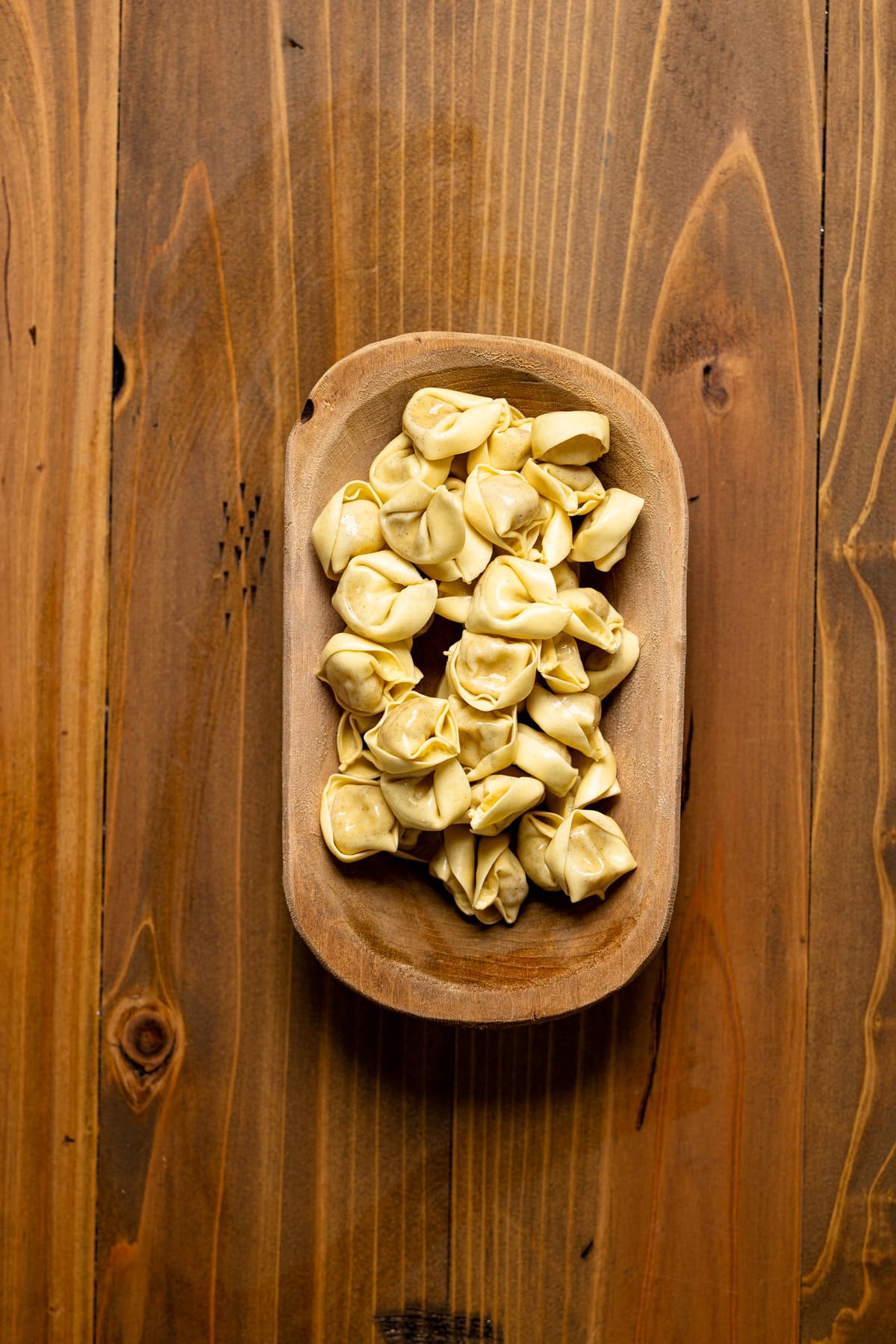 Wooden bowl of tortellini