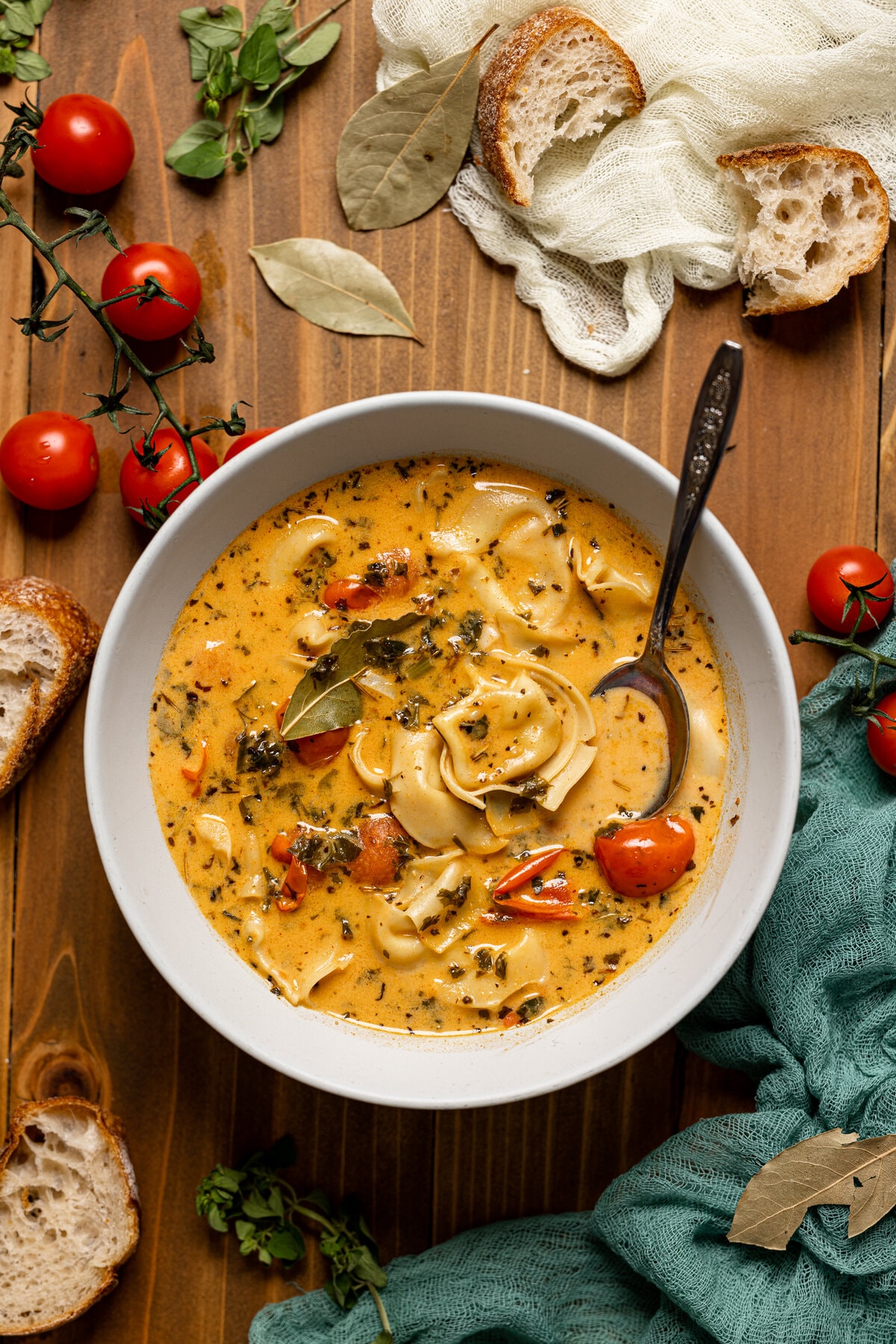 Bowl of creamy Tuscan tortellini soup with a spoon