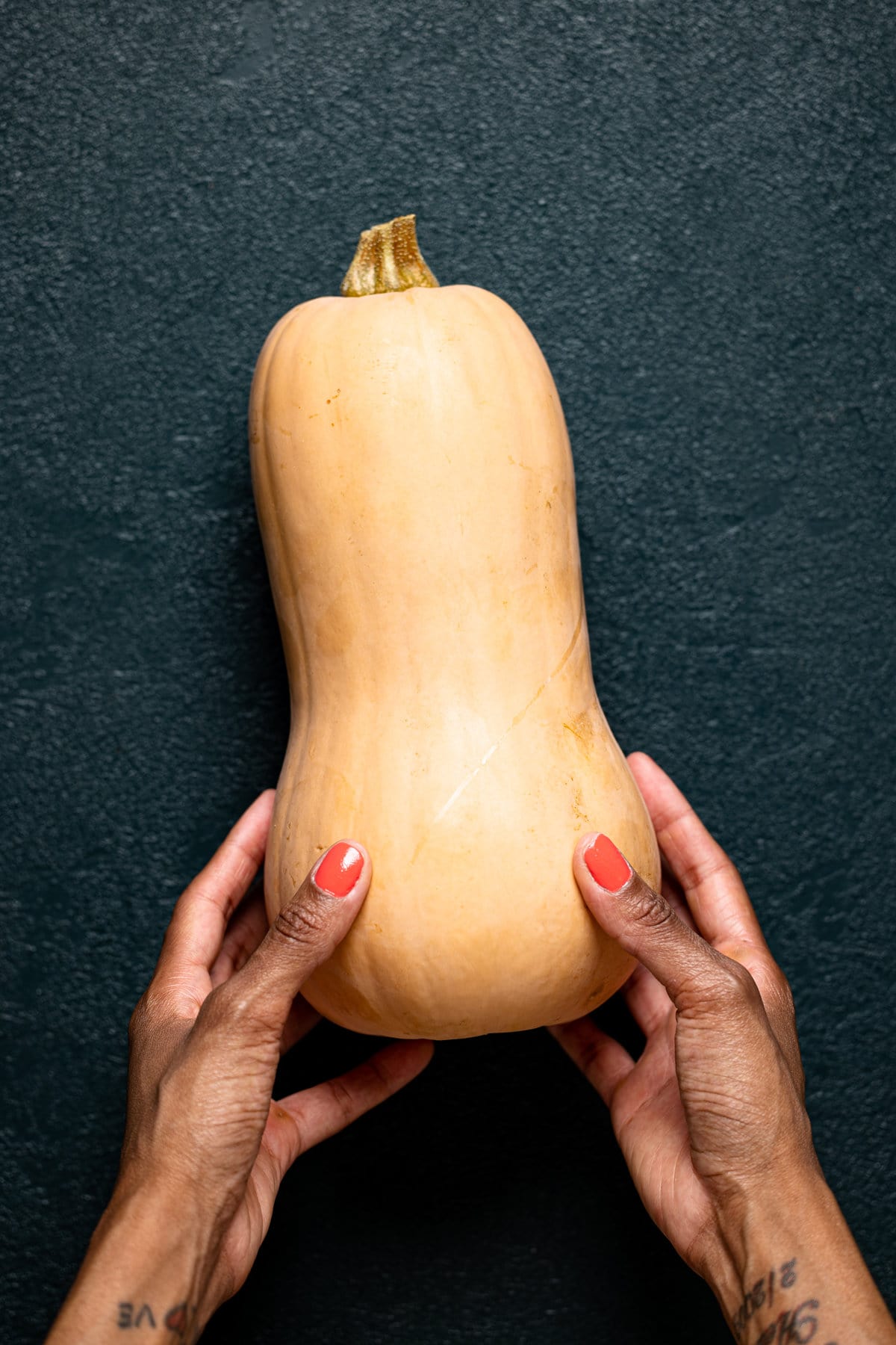 Hands holding a butternut squash