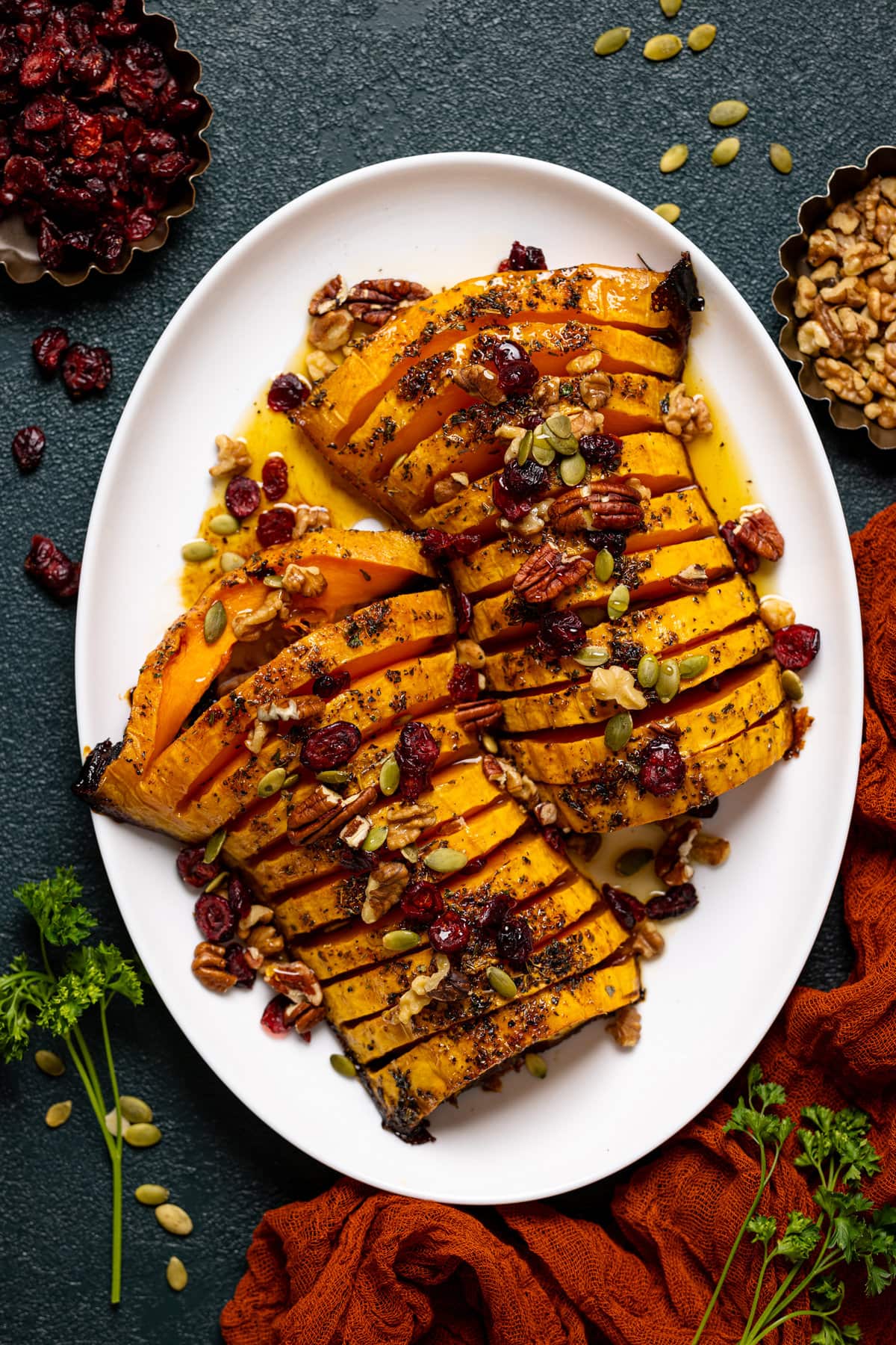 Plate of sliced Maple Herb Roasted Butternut Squash- The perfect vegan thanksgiving recipe!