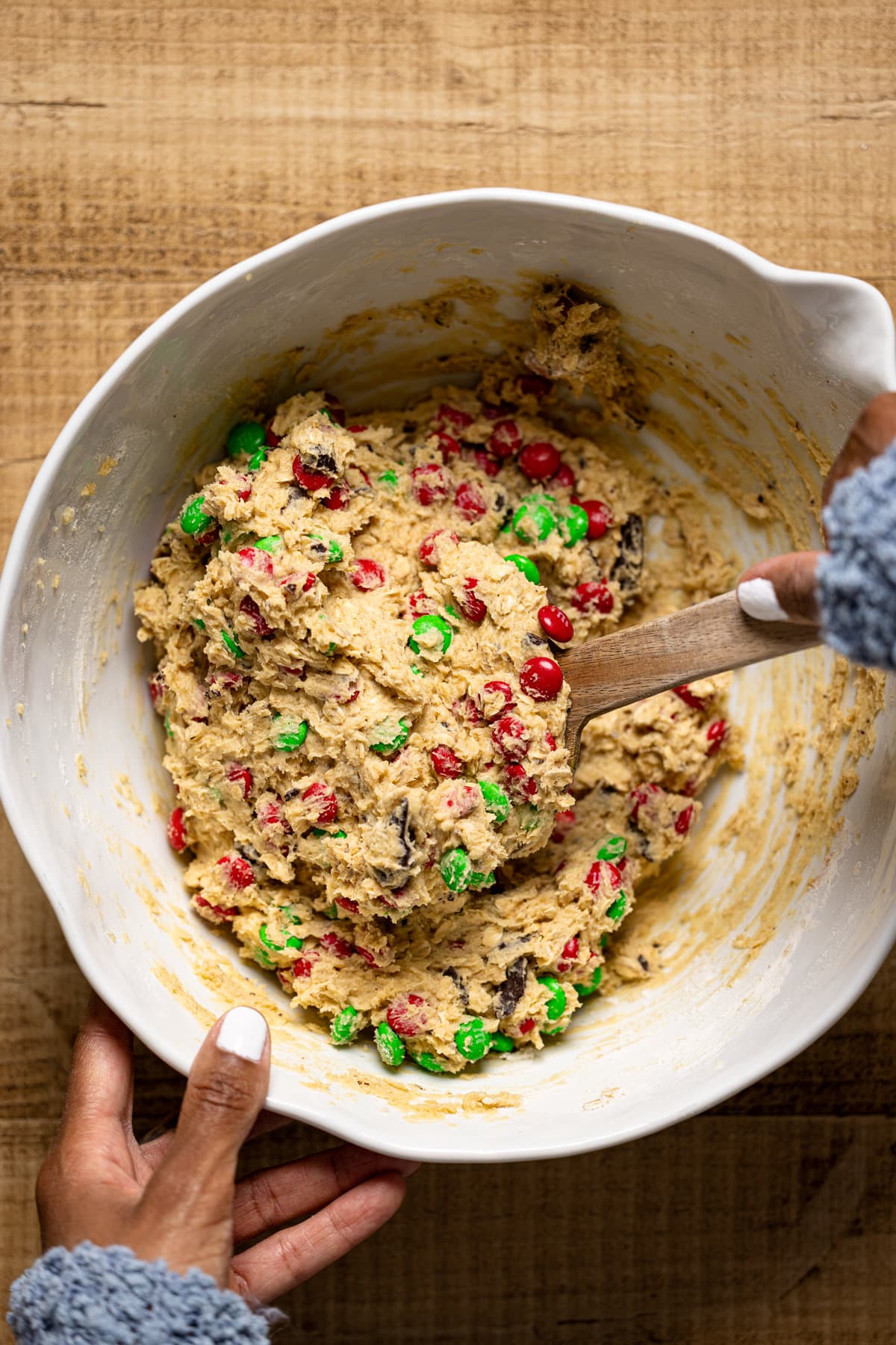 Christmas Monster Cookie dough being stirred in a bowl