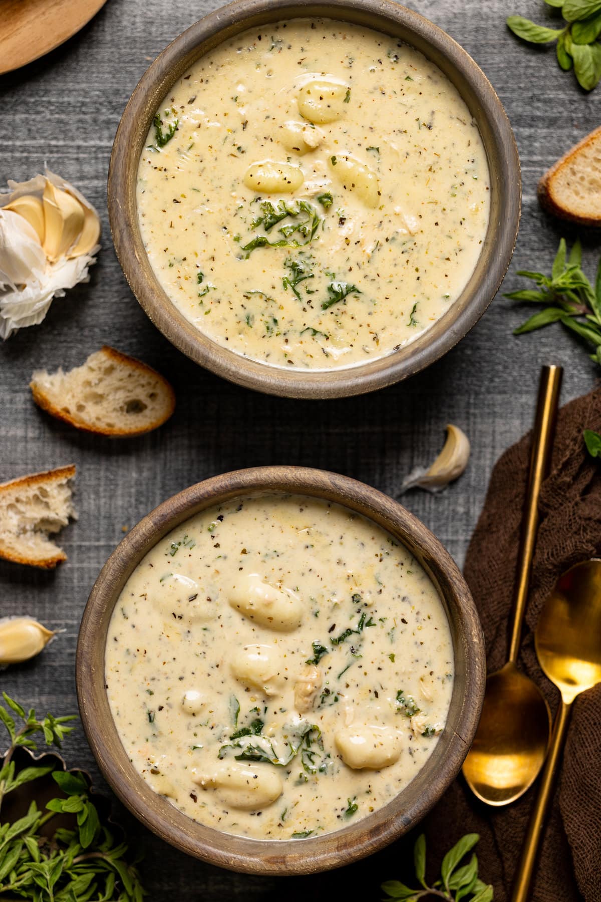 Closeup of two bowls of Creamy Garlic Chicken Gnocchi Soup