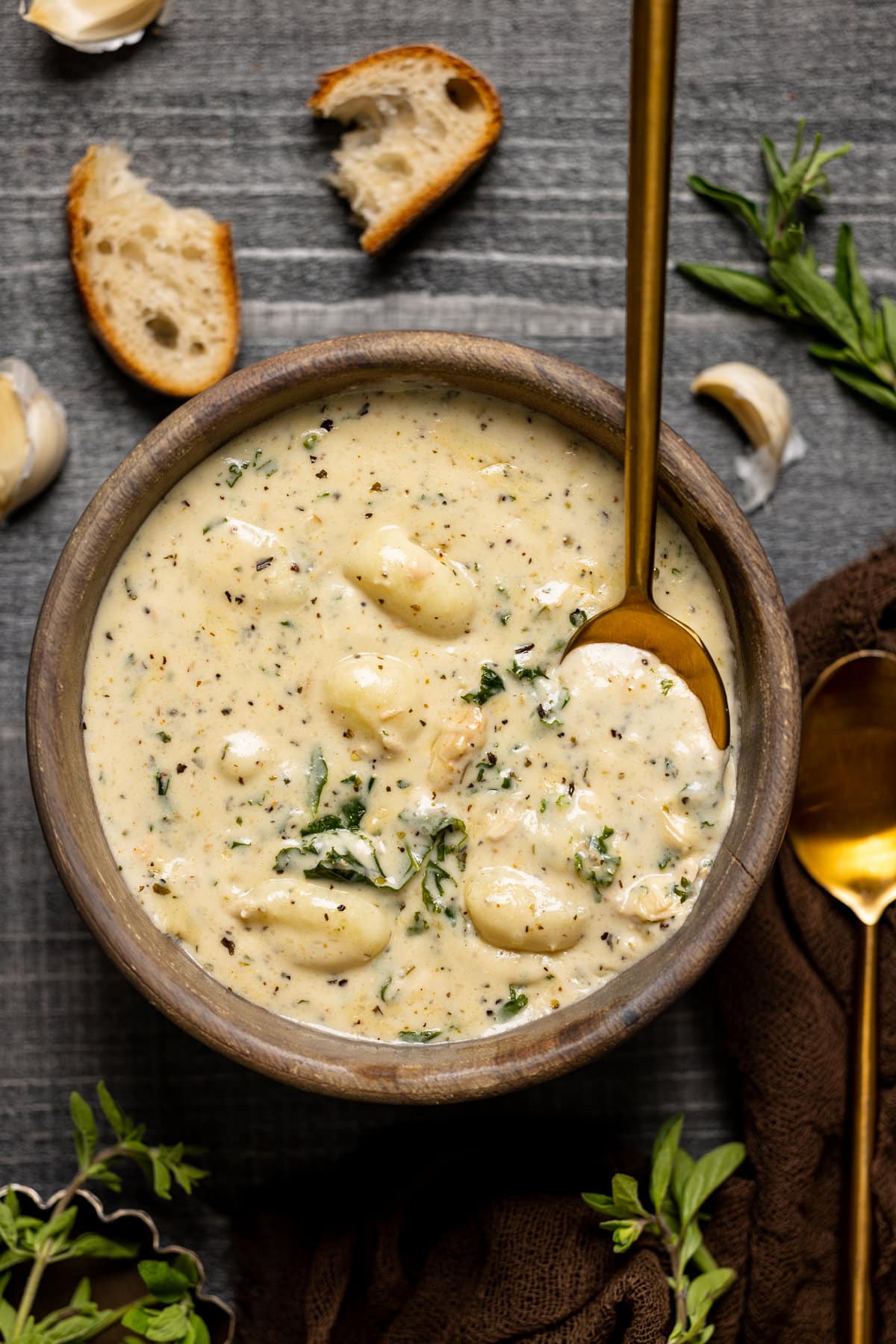 Bowl of Creamy Garlic Chicken Gnocchi Soup with a spoon