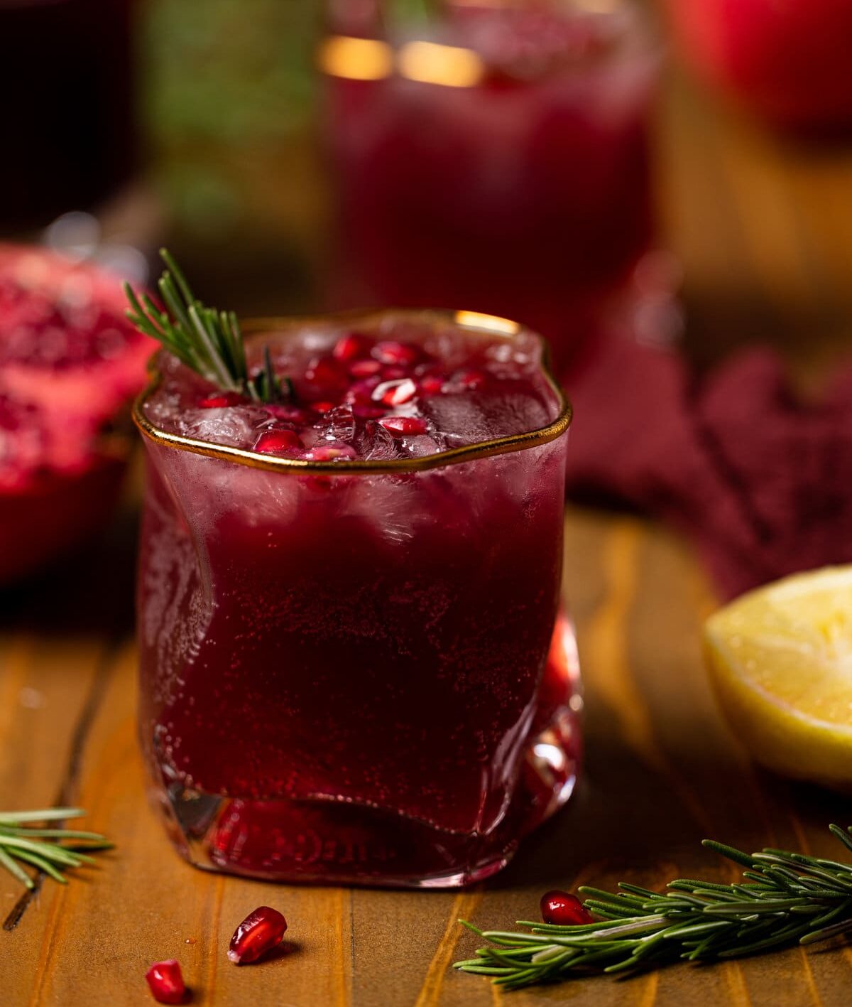 Closeup of a Holiday Pomegranate Ginger Mocktail in a gold-rimmed glass