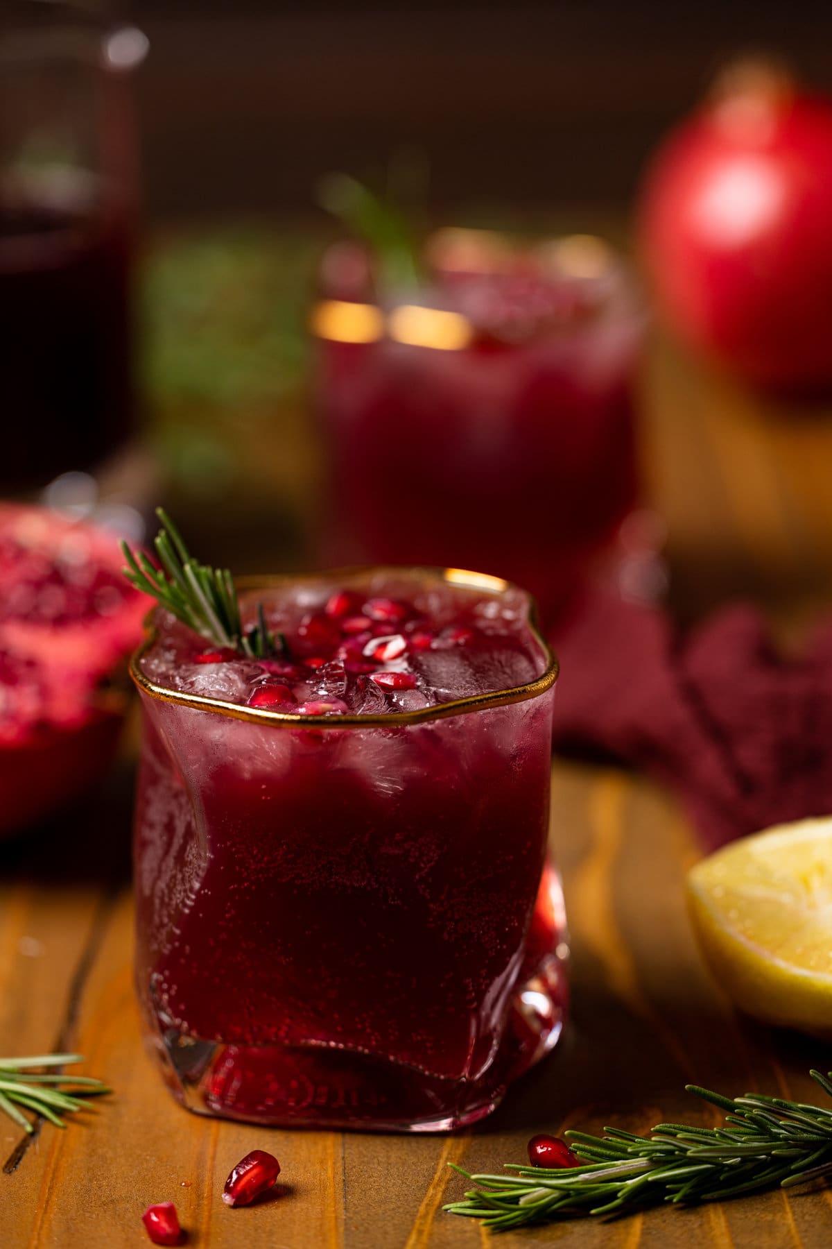 Closeup of a Holiday Pomegranate Ginger Mocktail in a gold-rimmed glass