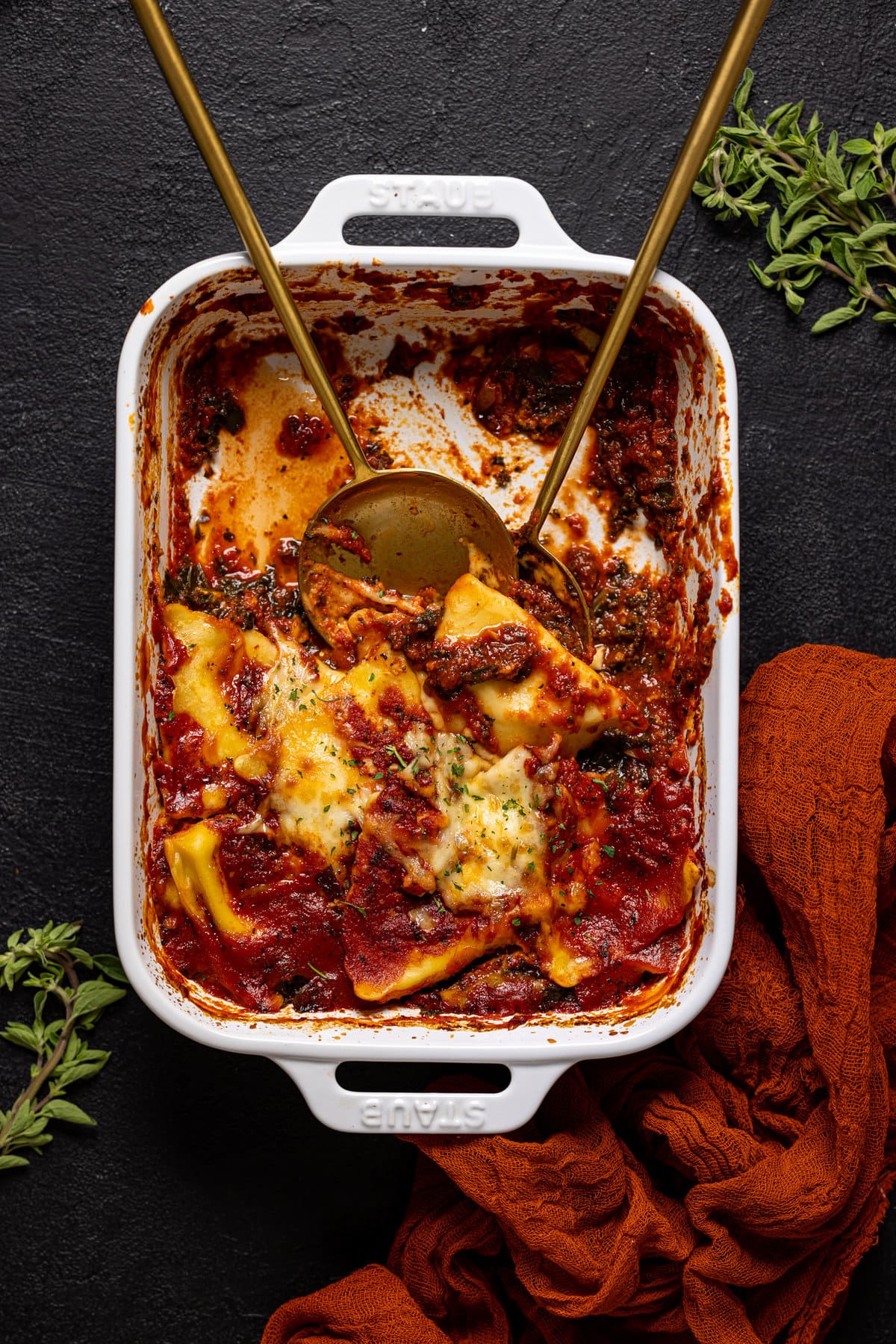 Half-served pan of Tomato Kale Ravioli Bake