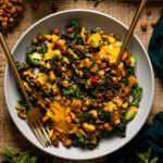 Bowl of Spicy Chipotle Sweet Potato Chopped Salad with utensils