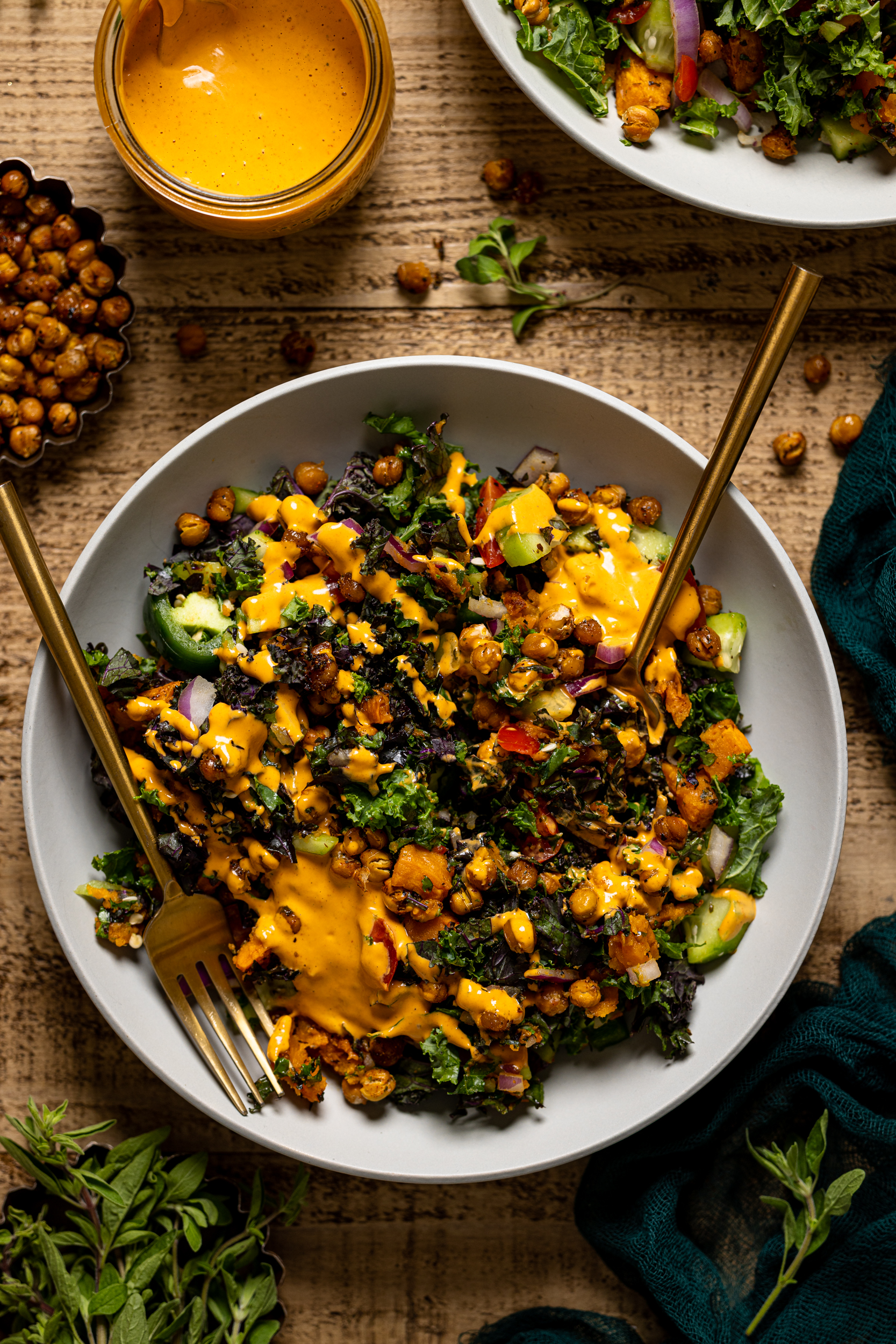 Bowl of Spicy Chipotle Sweet Potato Chopped Salad with utensils