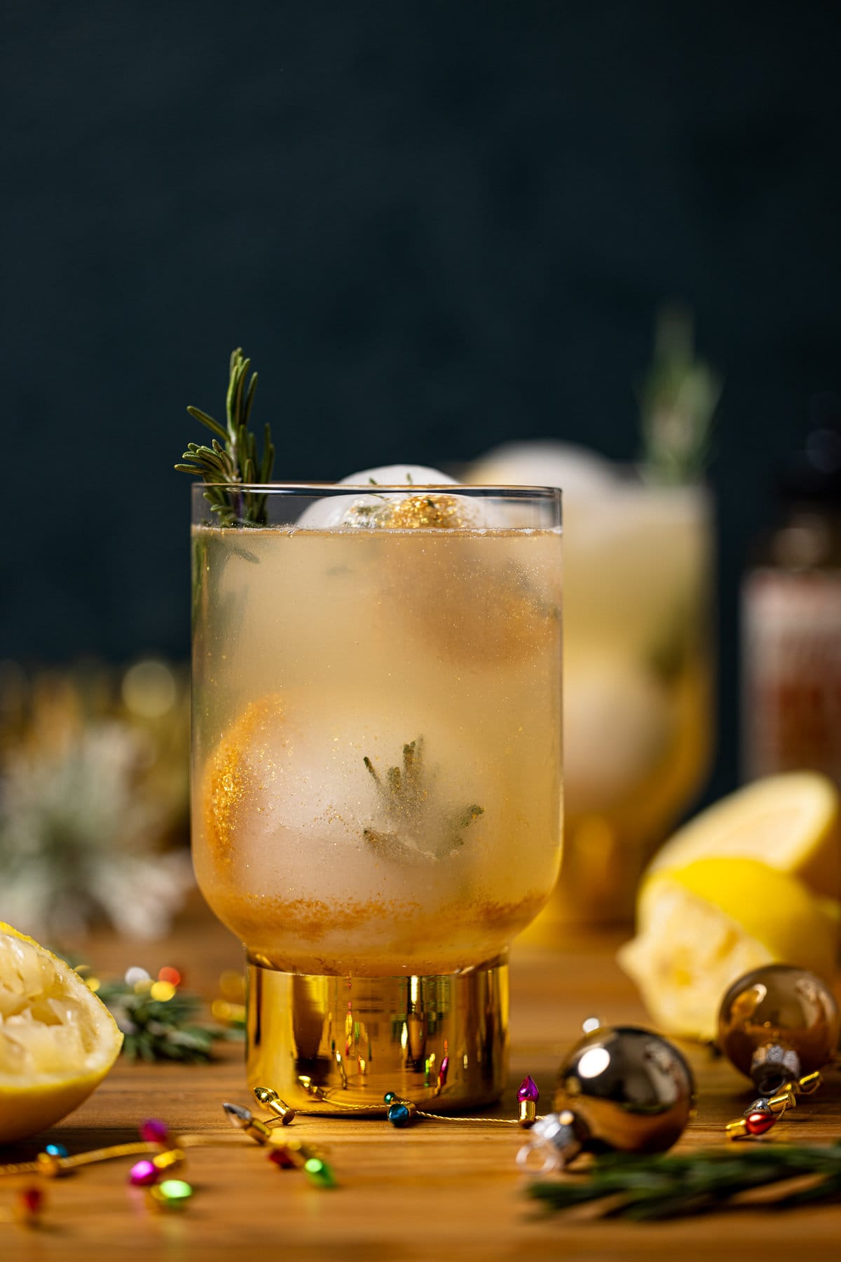 Glass of Hot Honey Lemon Mocktail with a sprig of rosemary sticking out