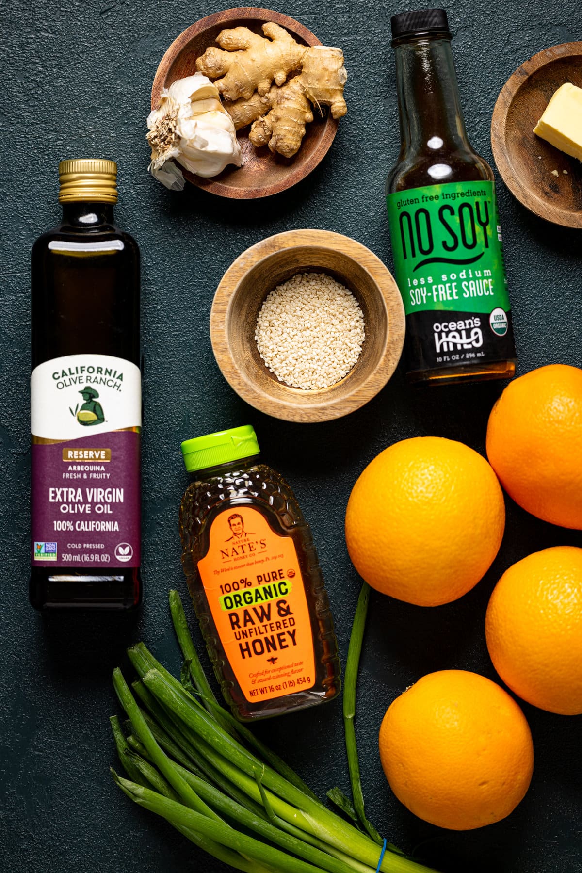 Ingredients for an Orange Salmon Bowl with Farro including honey, soy-free sauce, and ginger