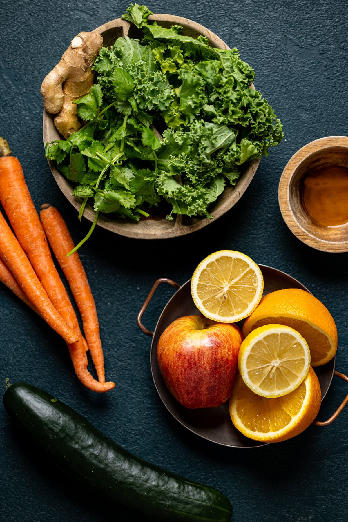 Ingredients for Cleansing Sugar Detox Juice including carrots, apples, oranges, and a cucumber