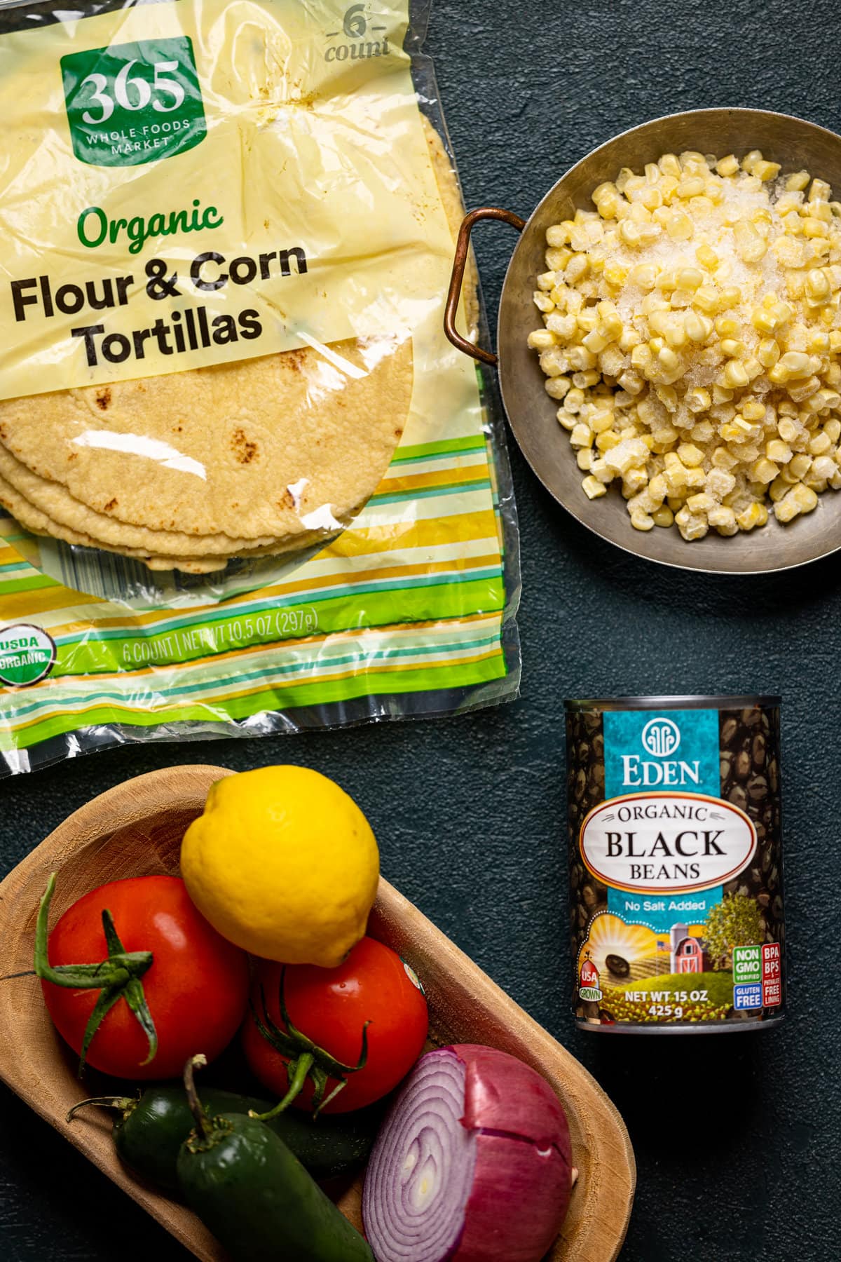 Ingredients for Baked Buffalo Chicken Tacos including tortillas, black beans, and frozen corn