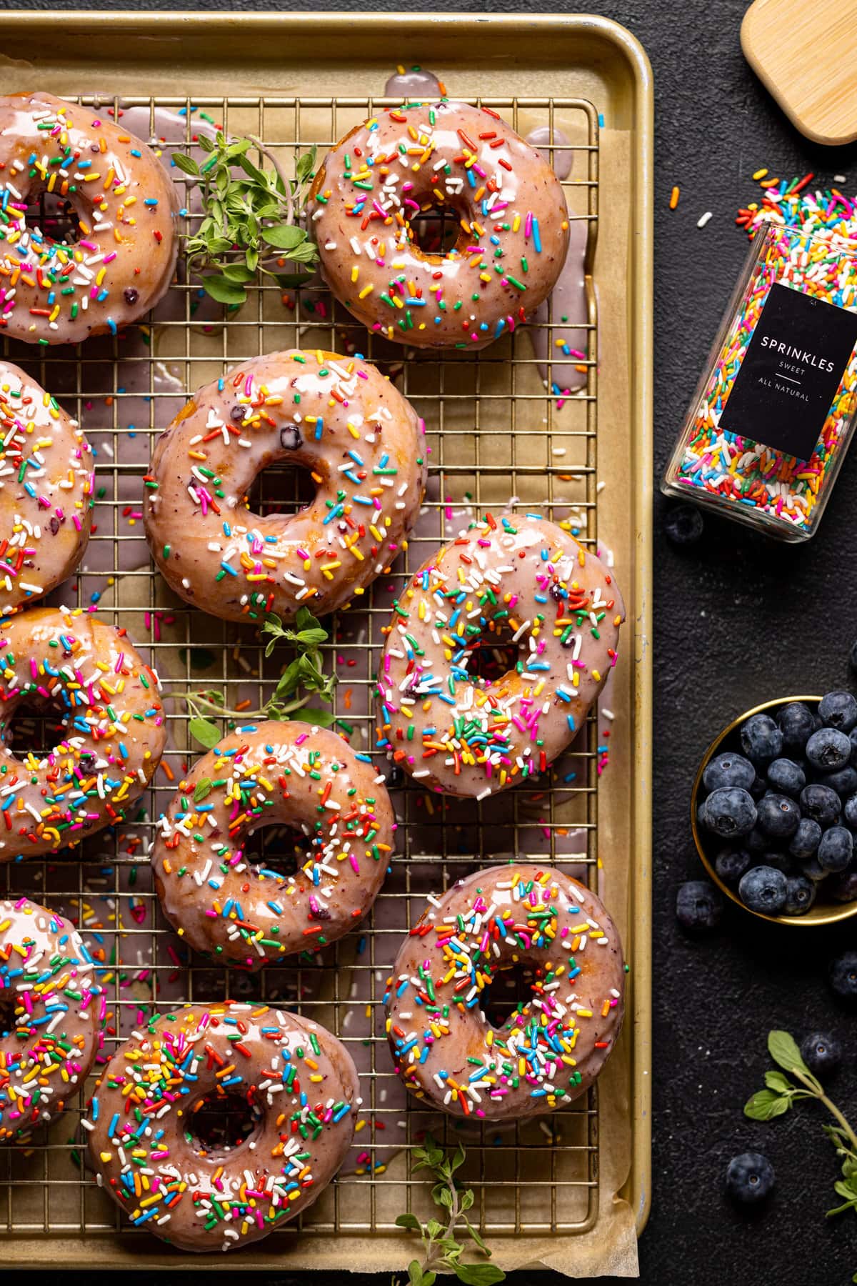 Lemon Blueberry Doughnuts with Sprinkles on a wire rack