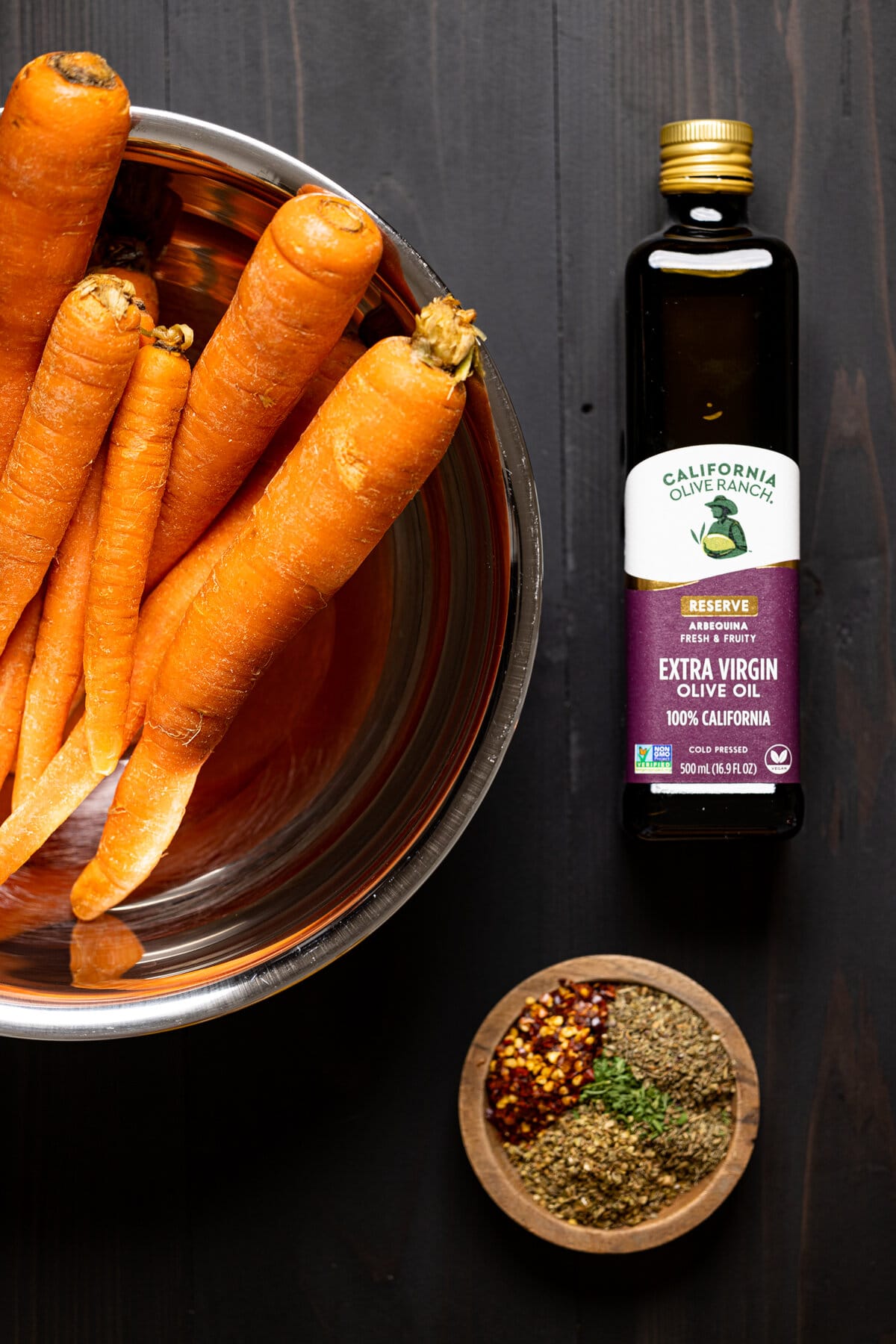 Ingredients for Roasted Carrot Soup including olive oil, carrots, and spices