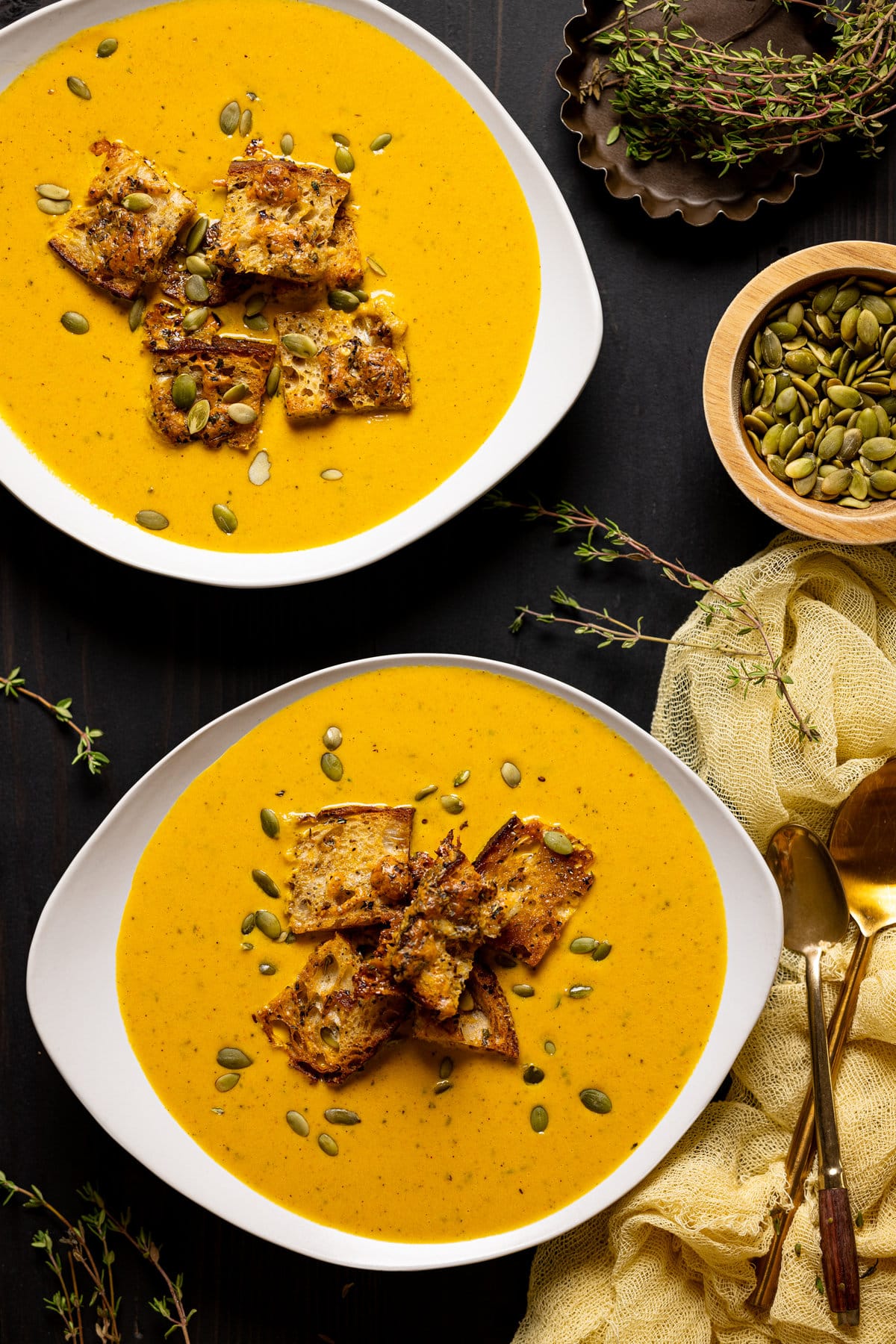 Two bowls of Roasted Carrot Soup with Cheesy Croutons