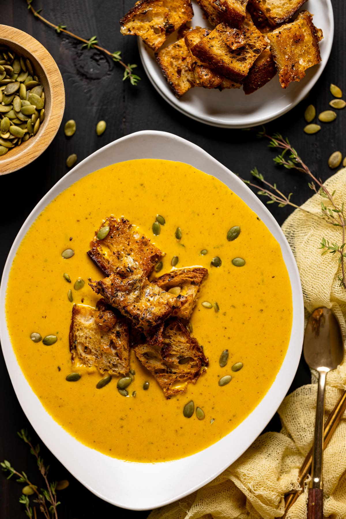 Closeup of a bowl of Roasted Carrot Soup with Cheesy Croutons