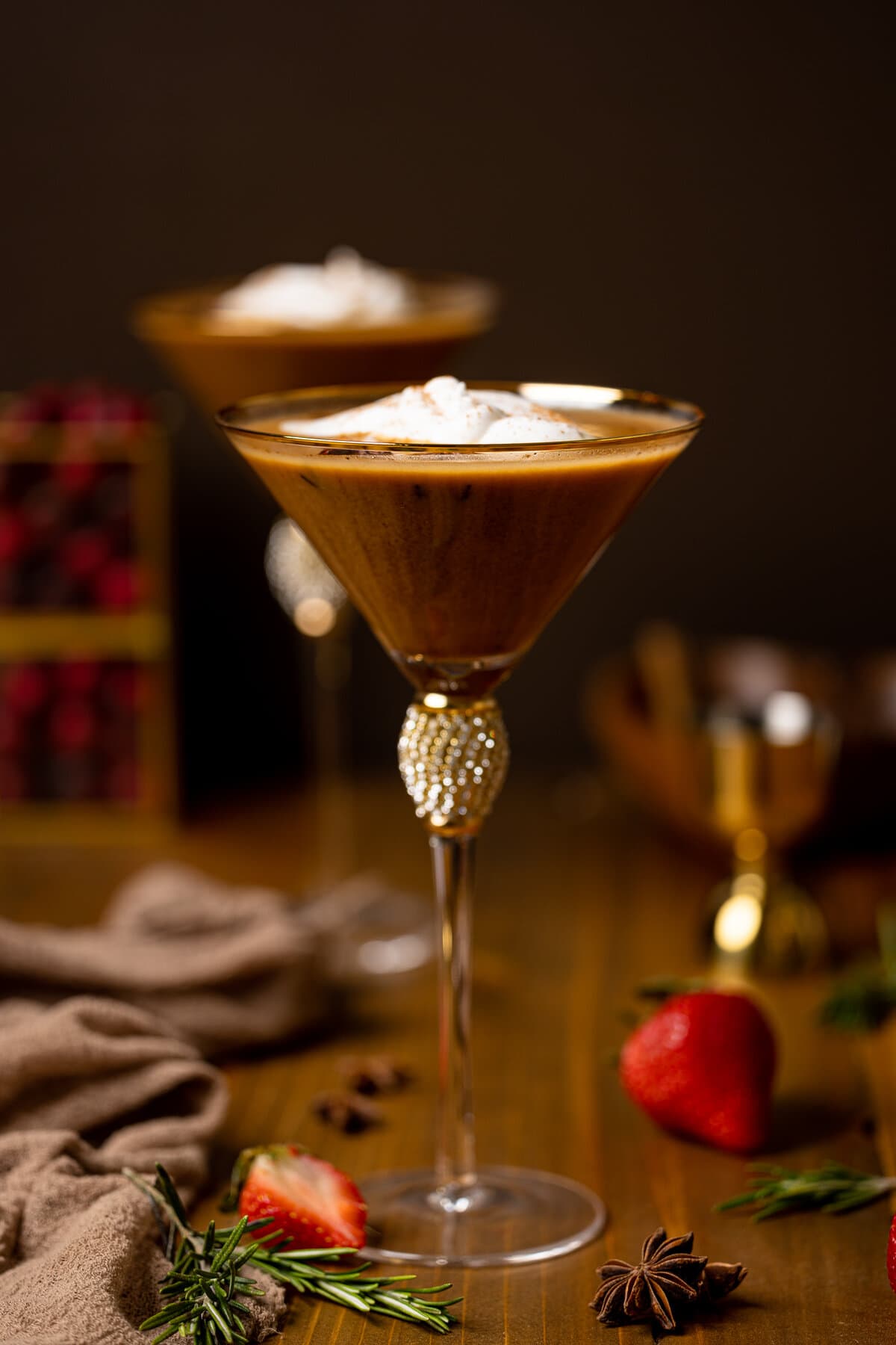 Dirty Chai Martini Mocktail in a jeweled martini glass next to strawberries