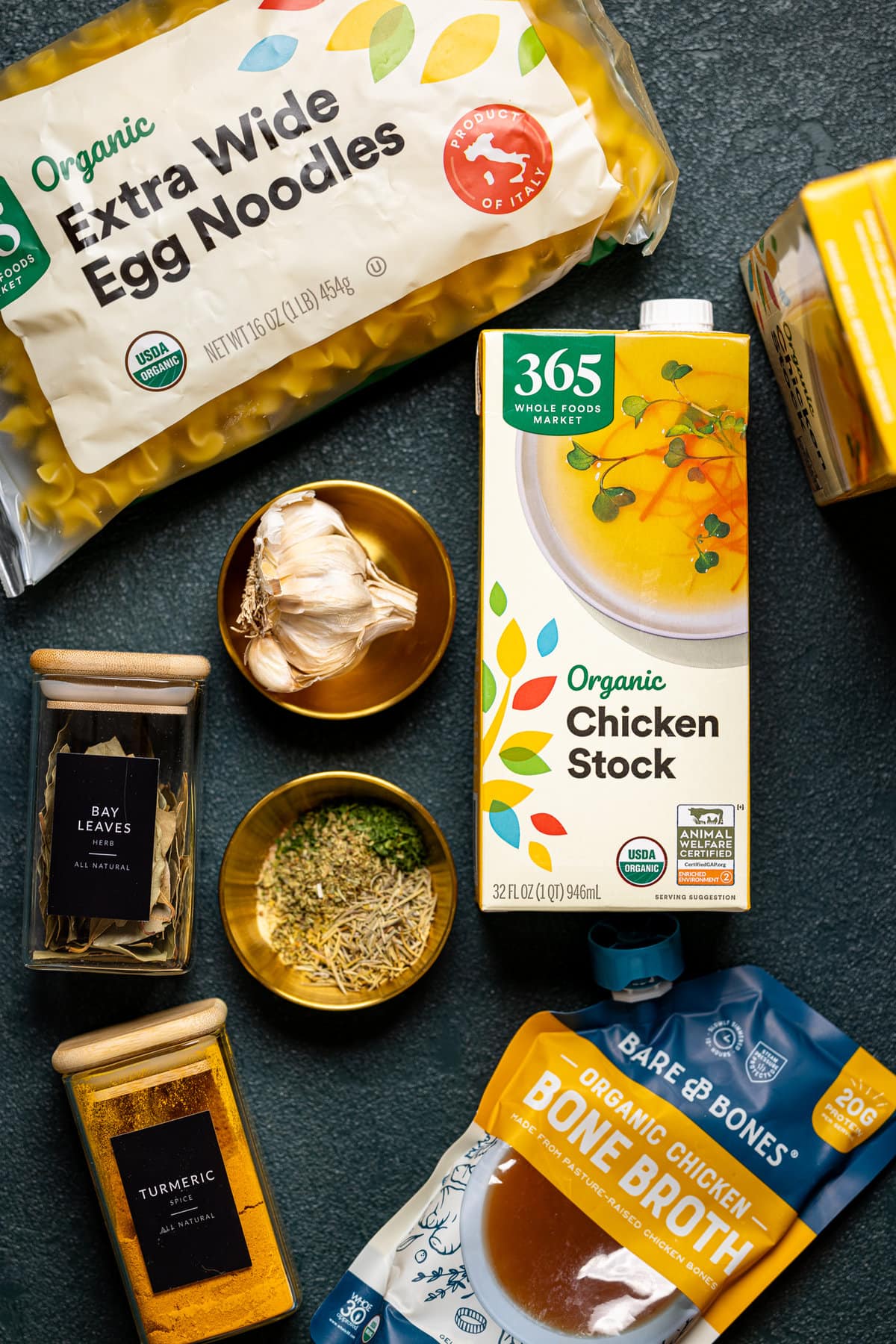 Ingredients for Nourishing Chicken Noodle Soup including chicken stock, egg noodles, garlic, and bone broth