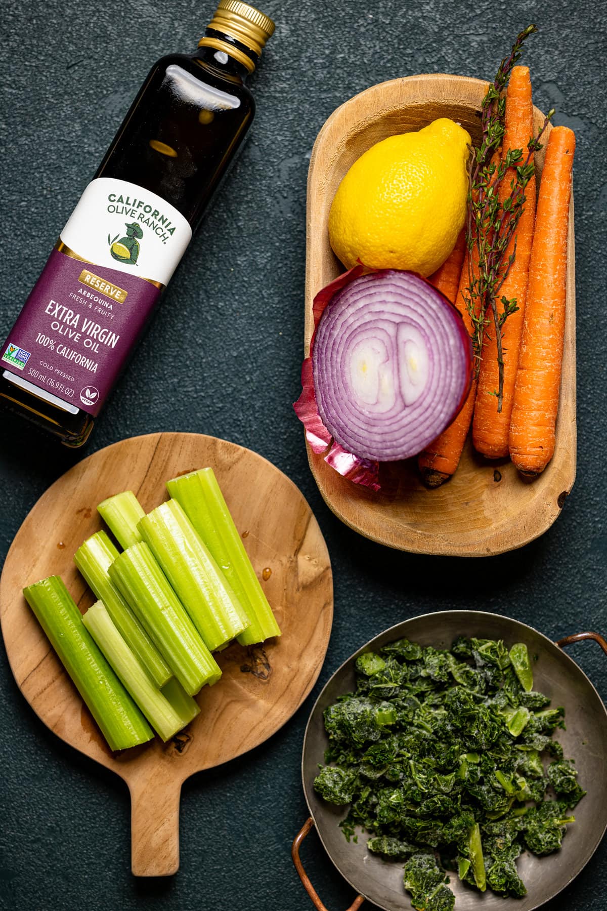 Ingredients for Nourishing Chicken Noodle Soup including celery, onion, carrots, and olive oil