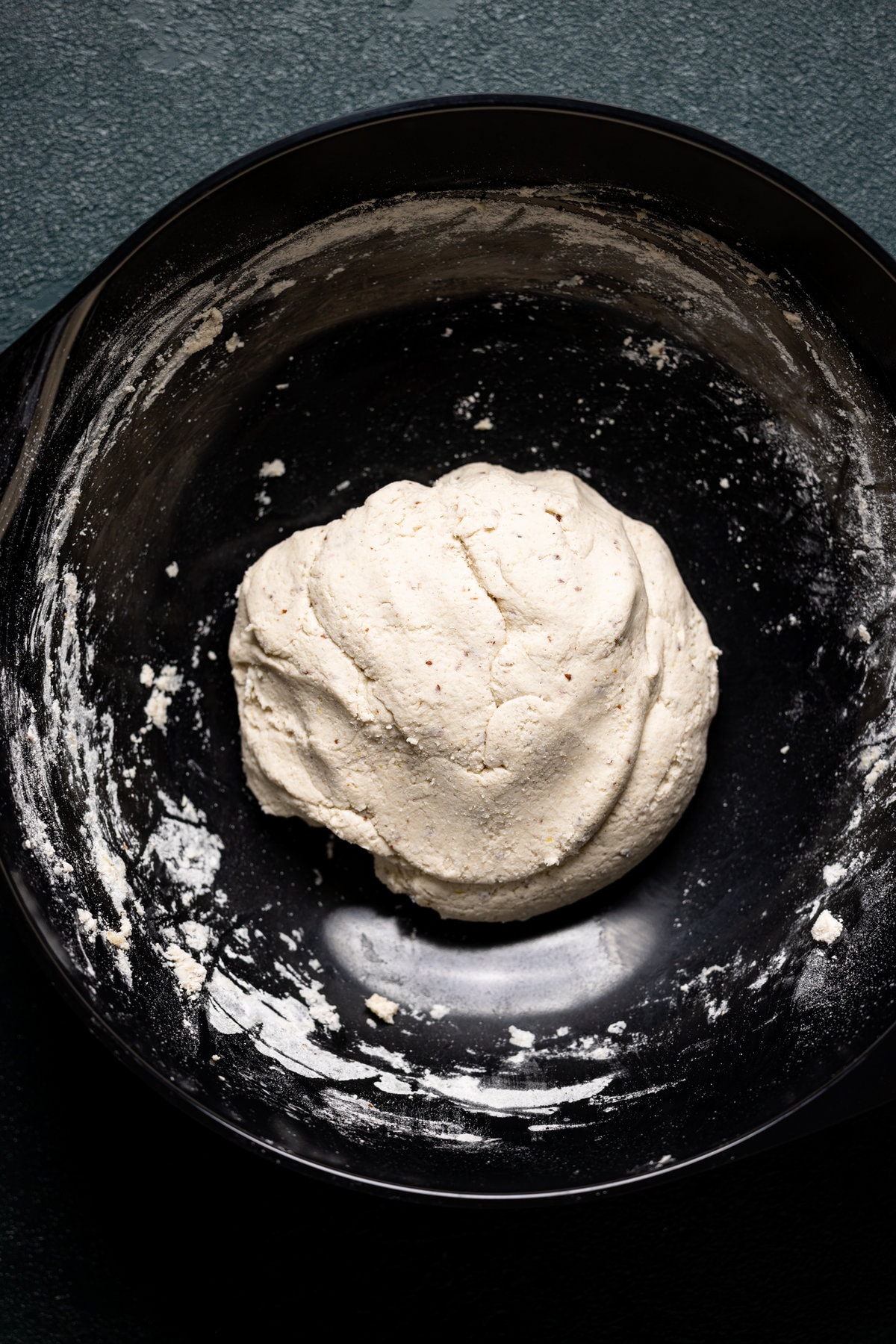 Gluten-Free Hot Honey Bacon Pizza dough in a black bowl