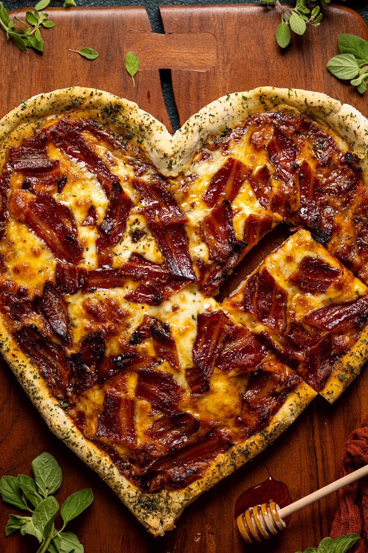 Closeup of heart-shaped Gluten-Free Hot Honey Bacon Pizza