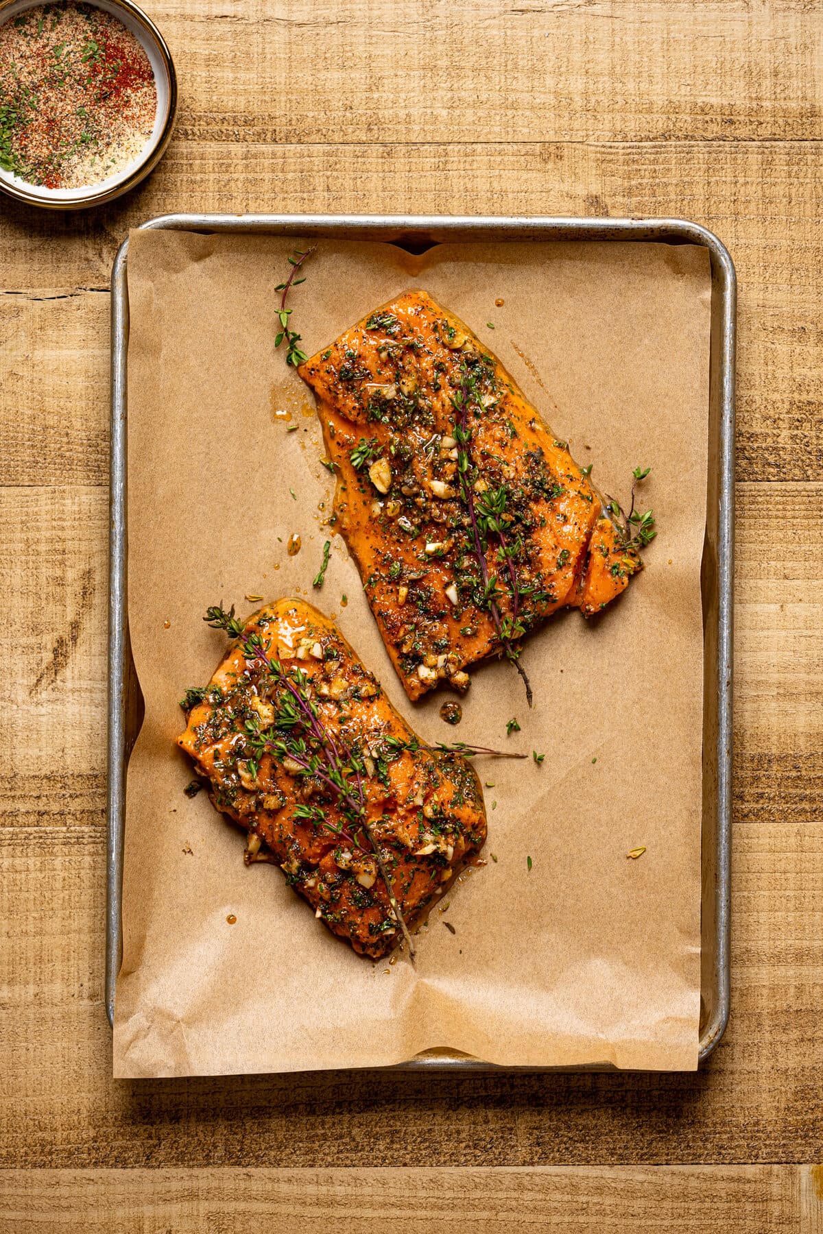 Seasoned salmon on a baking sheet