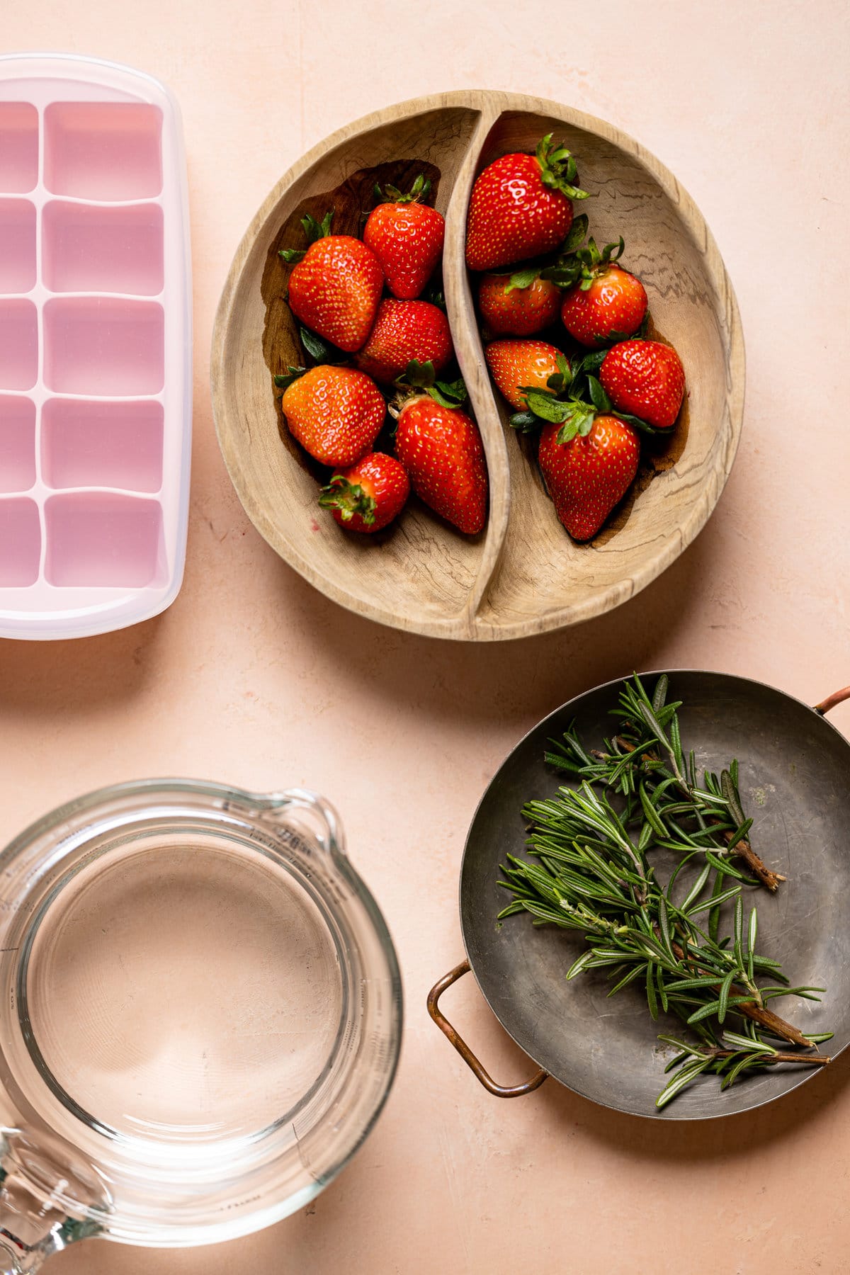 Strawberries, rosemary, and the equipment to turn them into ice cubes