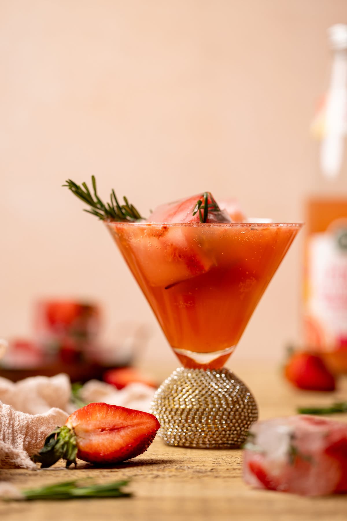 Closeup of a Strawberry Grapefruit Mocktail in a jeweled cocktail glass
