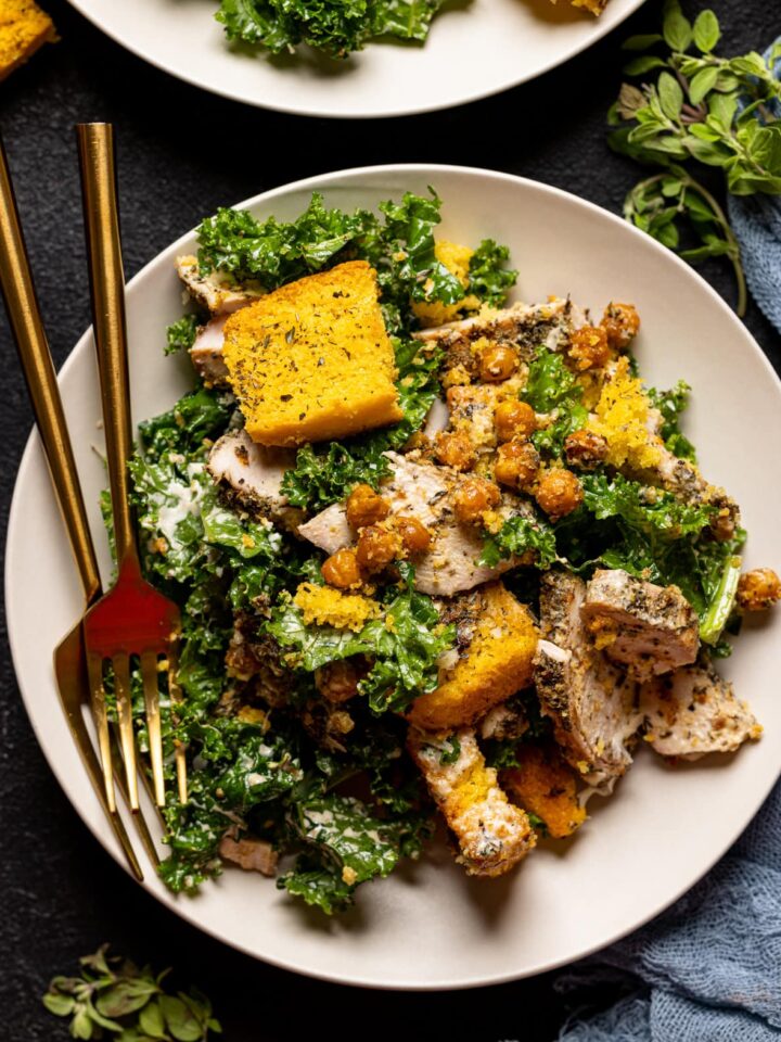 Forks and plate of Chicken Caesar Salad with Cornbread Croutons