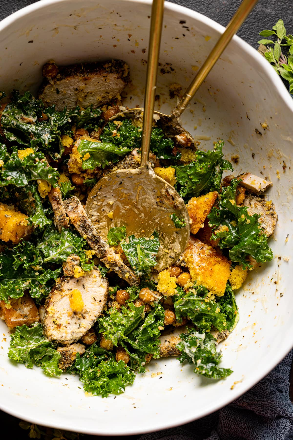 Bowl of Chicken Caesar Salad with Cornbread Croutons with two spoons