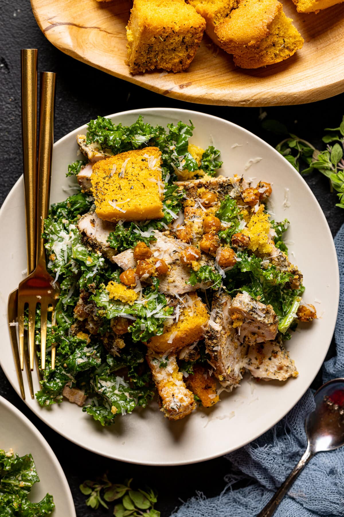 Chicken Caesar Salad with Cornbread Croutons topped with vegan Parmesan cheese