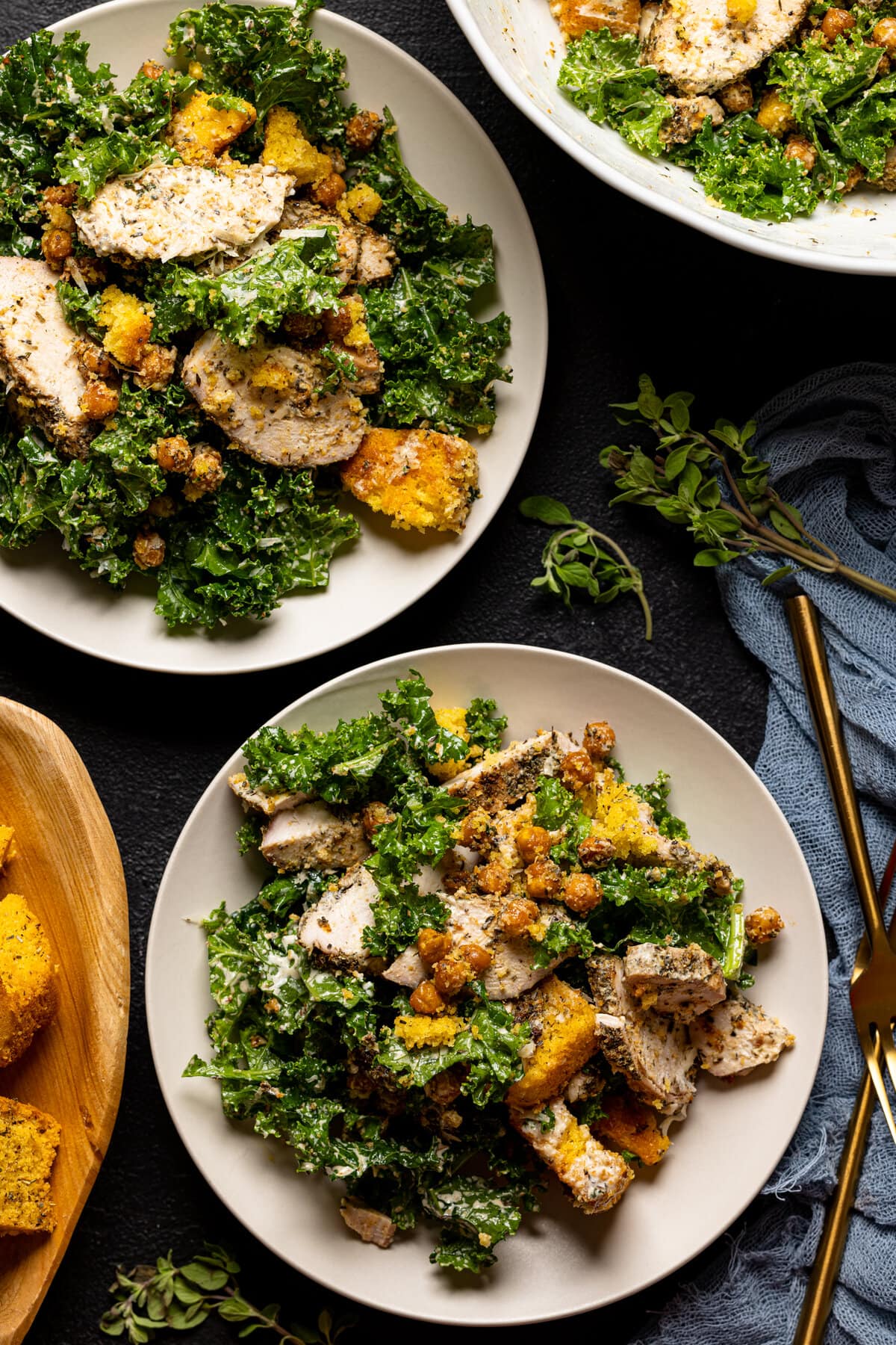 Two plates of Chicken Caesar Salad with Cornbread Croutons