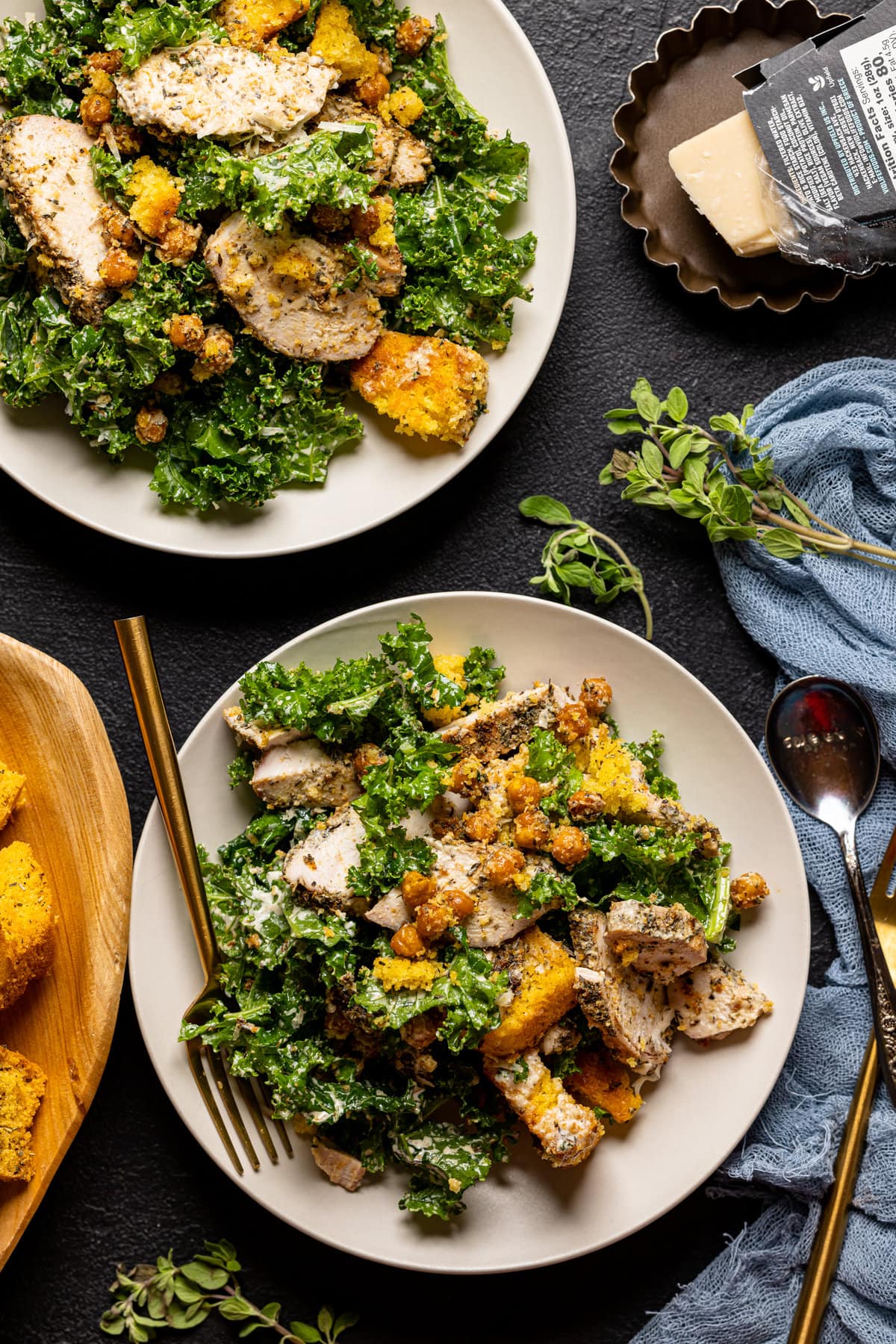 Two plates of Chicken Caesar Salad with Cornbread Croutons