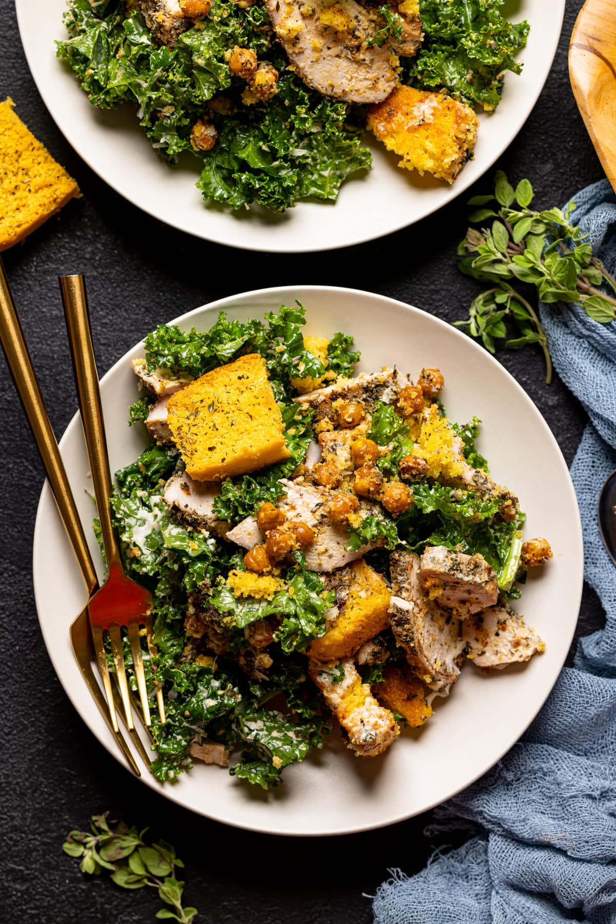 Chicken Caesar Salad with Cornbread Croutons on a plate with two forks