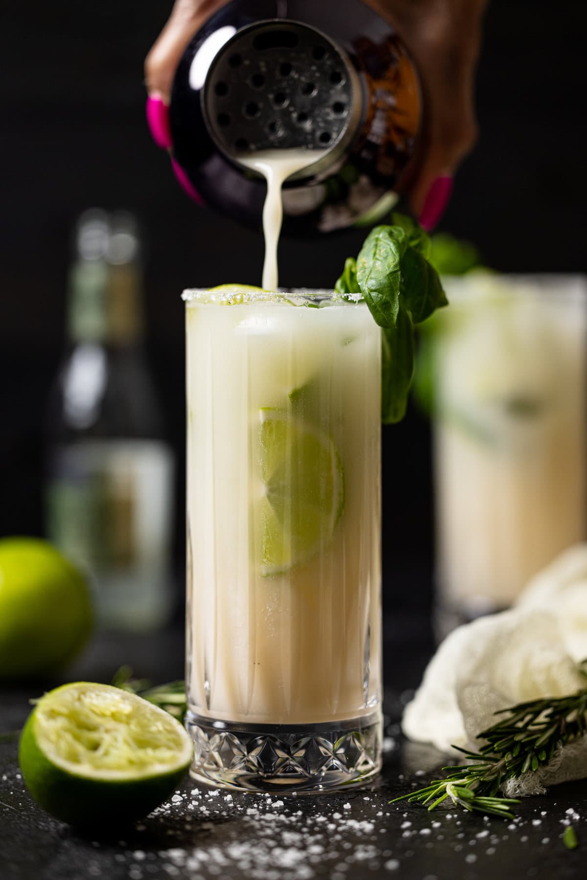 Tumbler pouring Coconut Mojito Mocktail into a glass
